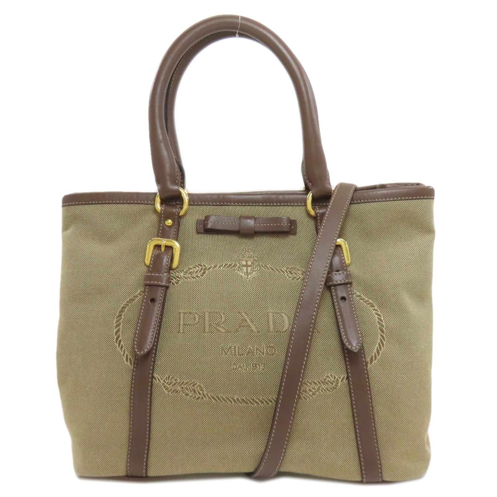 Handbag Canvas by Prada: Handbag Canvas by Prada Canvas by Prada is a women's handbag made from canvas, featuring a brown color and a shoulder strap. Measuring 21cm x 28cm x 16cm, it provides a compact and stylish option.