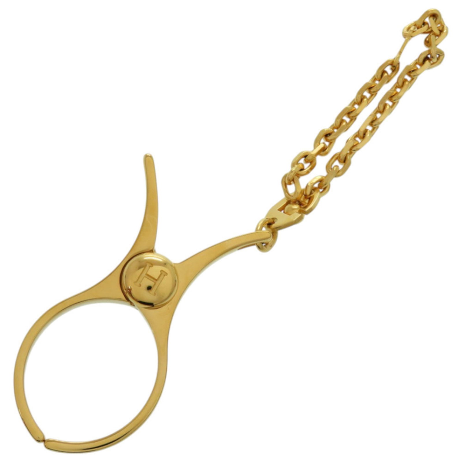 Glove Holder Metal by Hermes: Glove Holder Metal by Hermes Gold Glove Holder by Hermes, a sleek metal accessory measuring 6cm x 3cm, comes in a sturdy box. This compact holder is crafted from metal and features a luxurious gold
