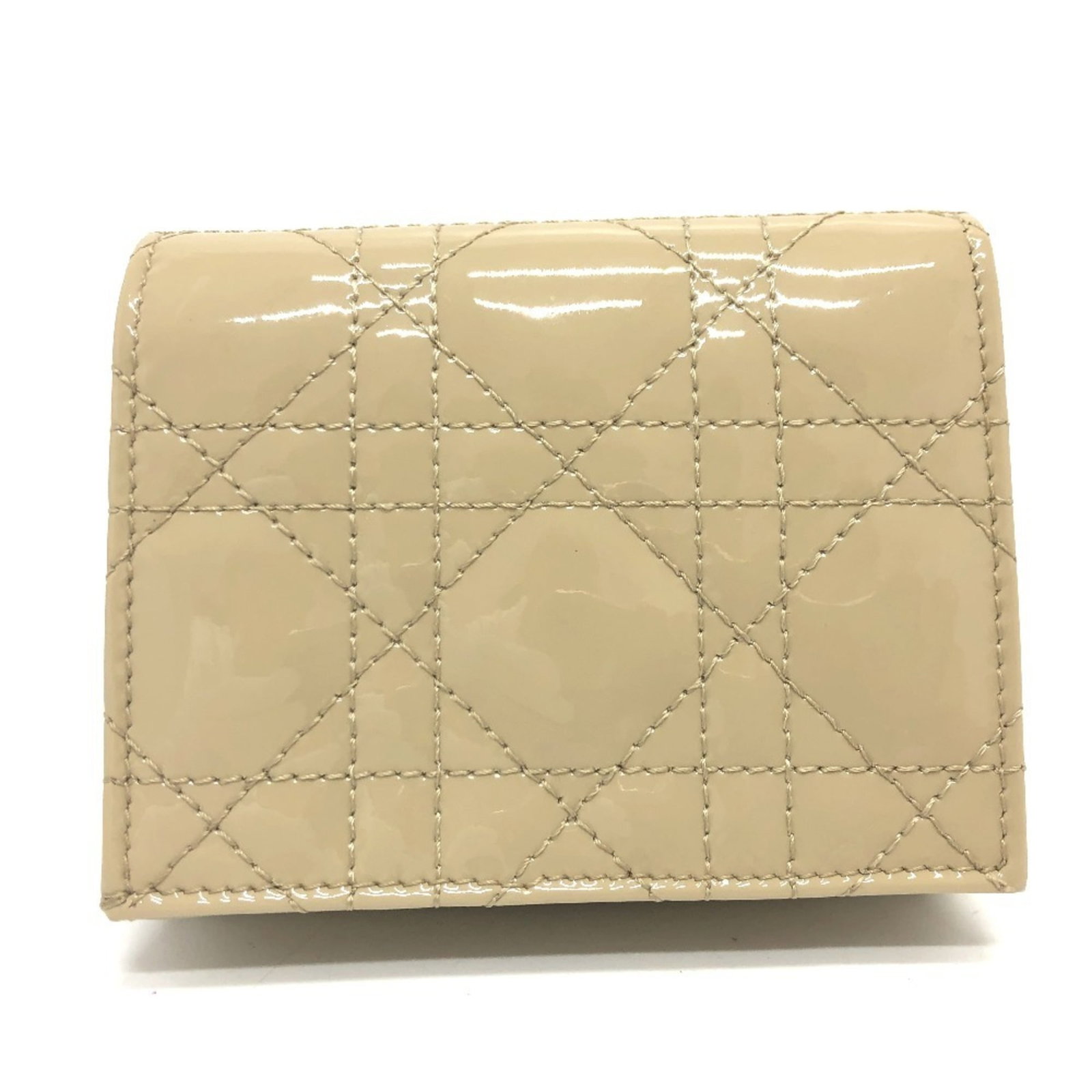 Dior Christian Wallet Leather Bi: Dior Christian Wallet Leather Bi Christian Dior Leather Bi Wallet. This classic bi-fold wallet features a timeless design in beige leather, with a subtle enamel touch. Its compact size makes it a prac