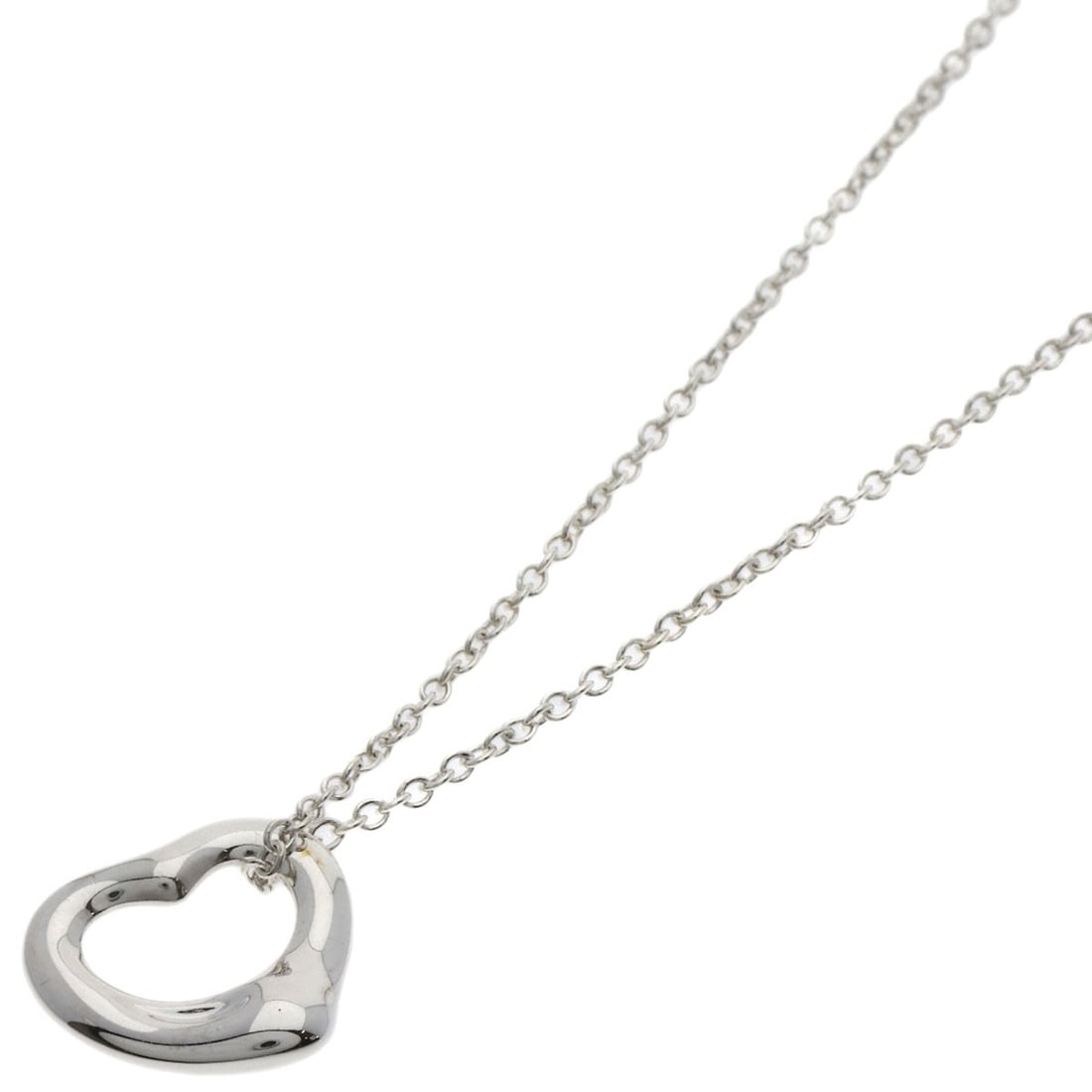 Open Heart Necklace by Tiffany & Co: Open Heart Necklace by Tiffany & Co The Open Heart Necklace by Tiffany & Co is a stunning silver necklace featuring a sleek design. With a length of 15.9 inches, it's a versatile piece that can be wor
