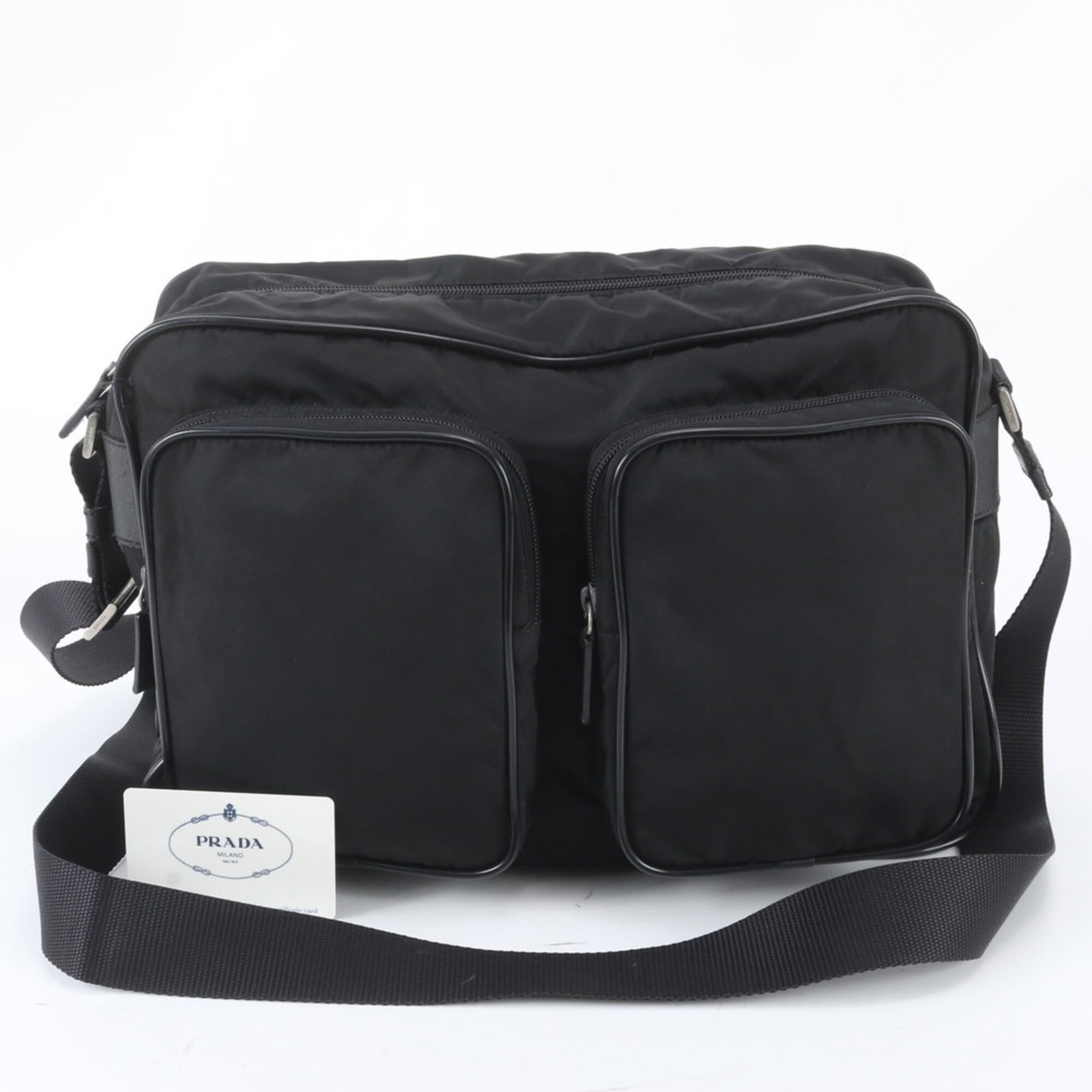 Shoulder Bag Nylon Leather Prada: Shoulder Bag Nylon Leather Prada Made from a combination of leather and nylon, this Prada shoulder bag boasts a sleek and durable design. Measuring 24cm x 37cm x 11cm, it features a classic black