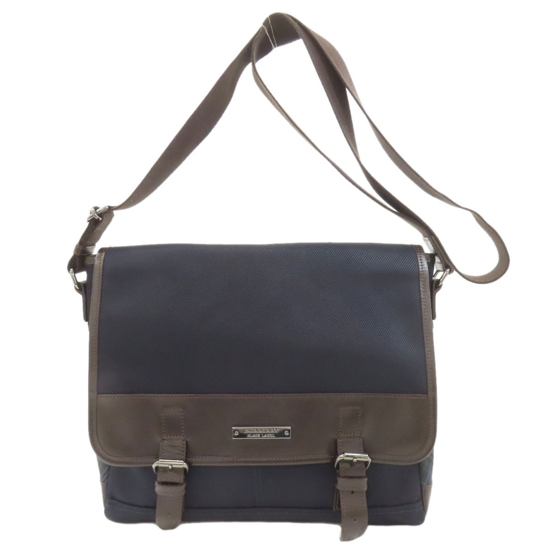 Canvas Leather Nylon Burberry Black Bag Label: Canvas Leather Nylon Burberry Black Bag Label Navy canvas leather nylon bag from BURBERRY, featuring a classic shoulder style with a durable nylon exterior. The bag bears a signature, adding a touch