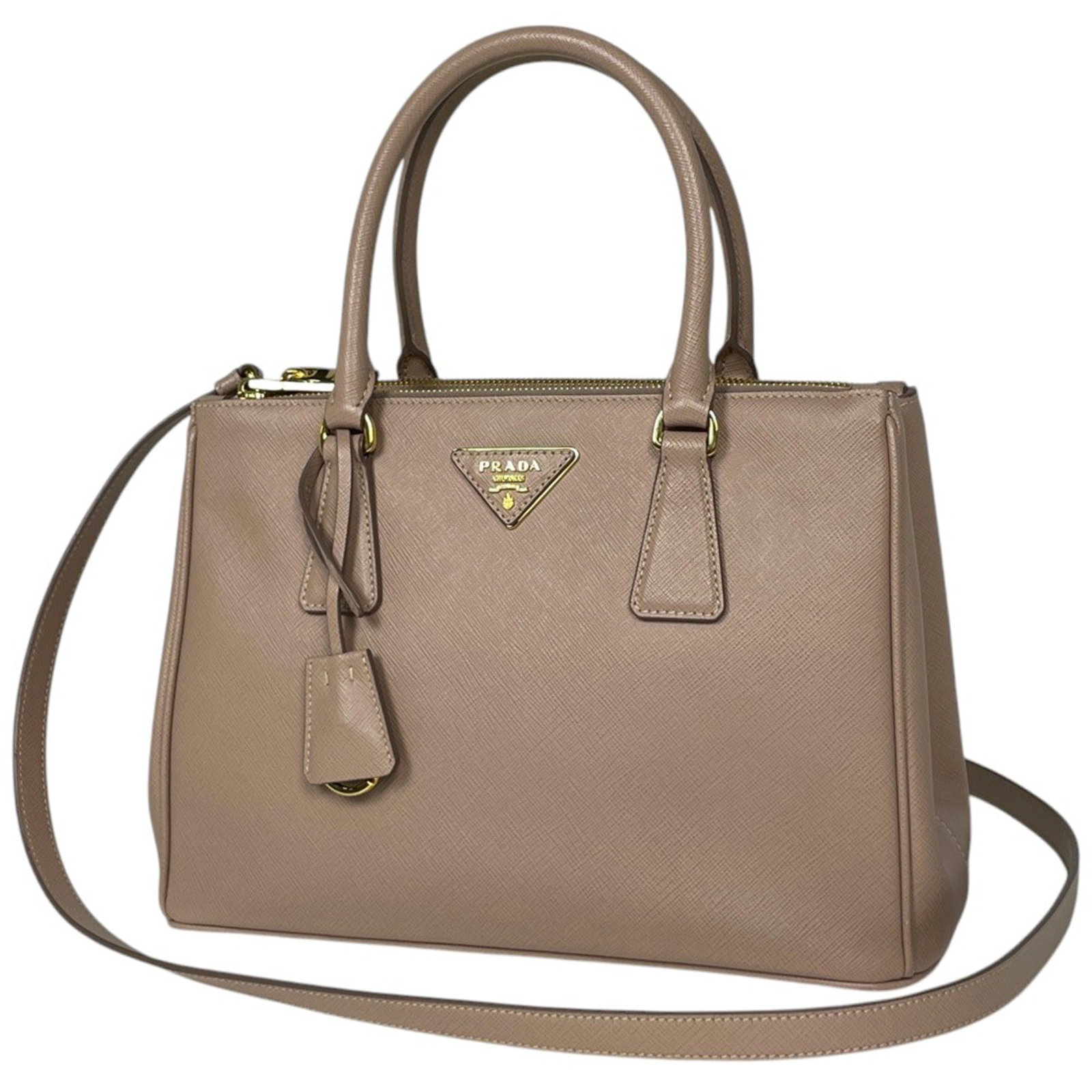 Handbag Leather Prada: Handbag Leather Prada Saffiano leather construction provides a durable and luxurious finish to this Prada handbag, while its classic beige color exudes timeless elegance. Measuring 20cm x 28cm x 12cm,