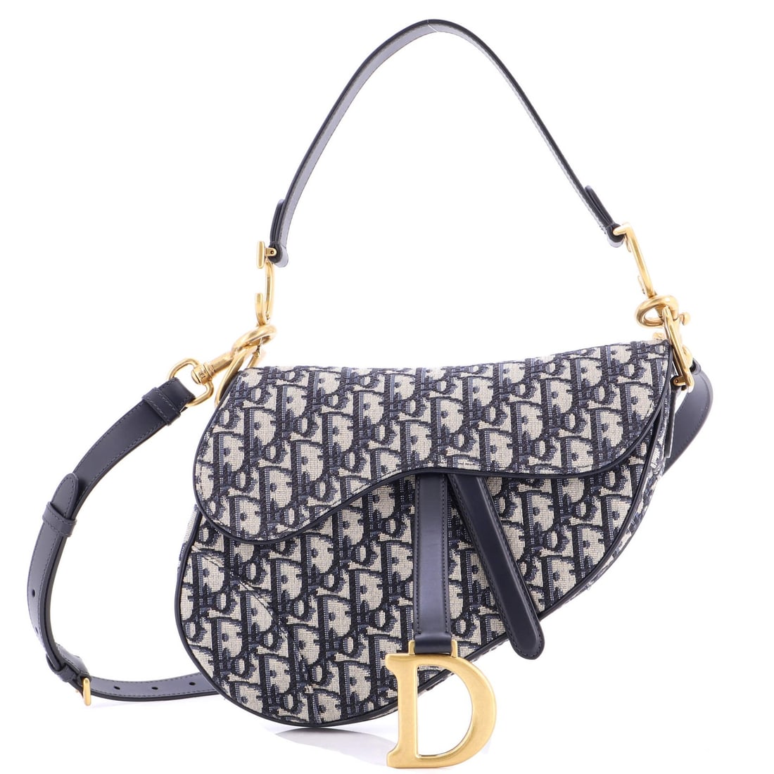 Saddle Handbag Strap Oblique Canvas Medium Christian Dior: Saddle Handbag Strap Oblique Canvas Medium Christian Dior Saddle Handbag with Strap Oblique Canvas Medium in Blue. This Christian Dior shoulder bag features a striking oblique canvas design and a stur