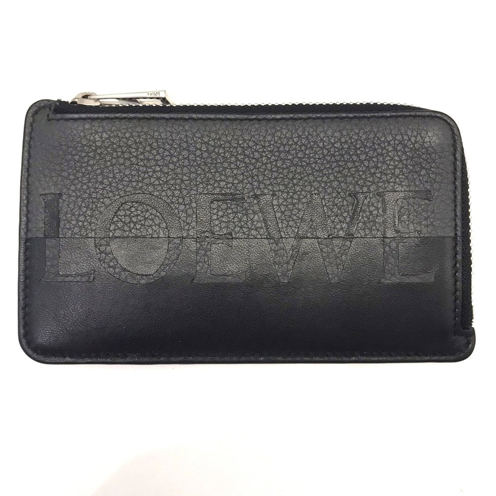 Loewe Coin Purse/ Coin Case Leather: Loewe Coin Purse/ Coin Case Leather The Loewe Coin Purse is a sleek and sophisticated leather accessory, available in both black and gray colors. Measuring 7.5cm x 12.5cm x 1cm, it features a sturdy