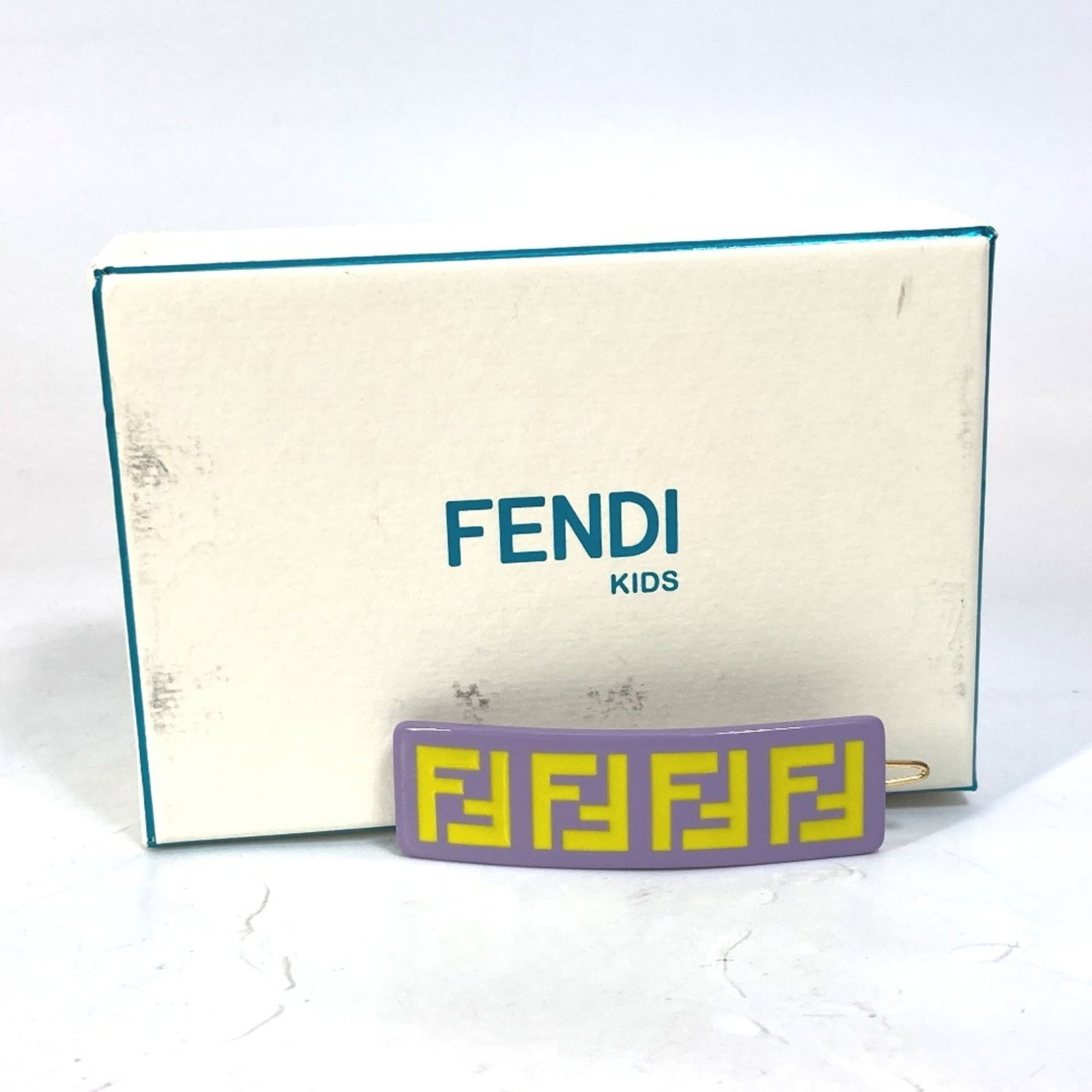 Hair Pin By Fendi: Hair Pin By Fendi Purple and yellow Fendi hair pin, packaged in a box. The hair pin is a notable accessory from the Fendi brand. Item Specifics: Brand: Fendi Type: Hair pin Gender: Girls Color: Purple