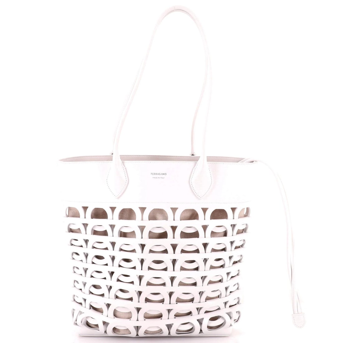 Laser Cut Leather Gancini Tote Salvatore Ferragamo: Laser Cut Leather Gancini Tote Salvatore Ferragamo Laser cut leather exterior adds a touch of sophistication to this Salvatore Ferragamo Gancini Tote, featuring a crisp white exterior and neutral