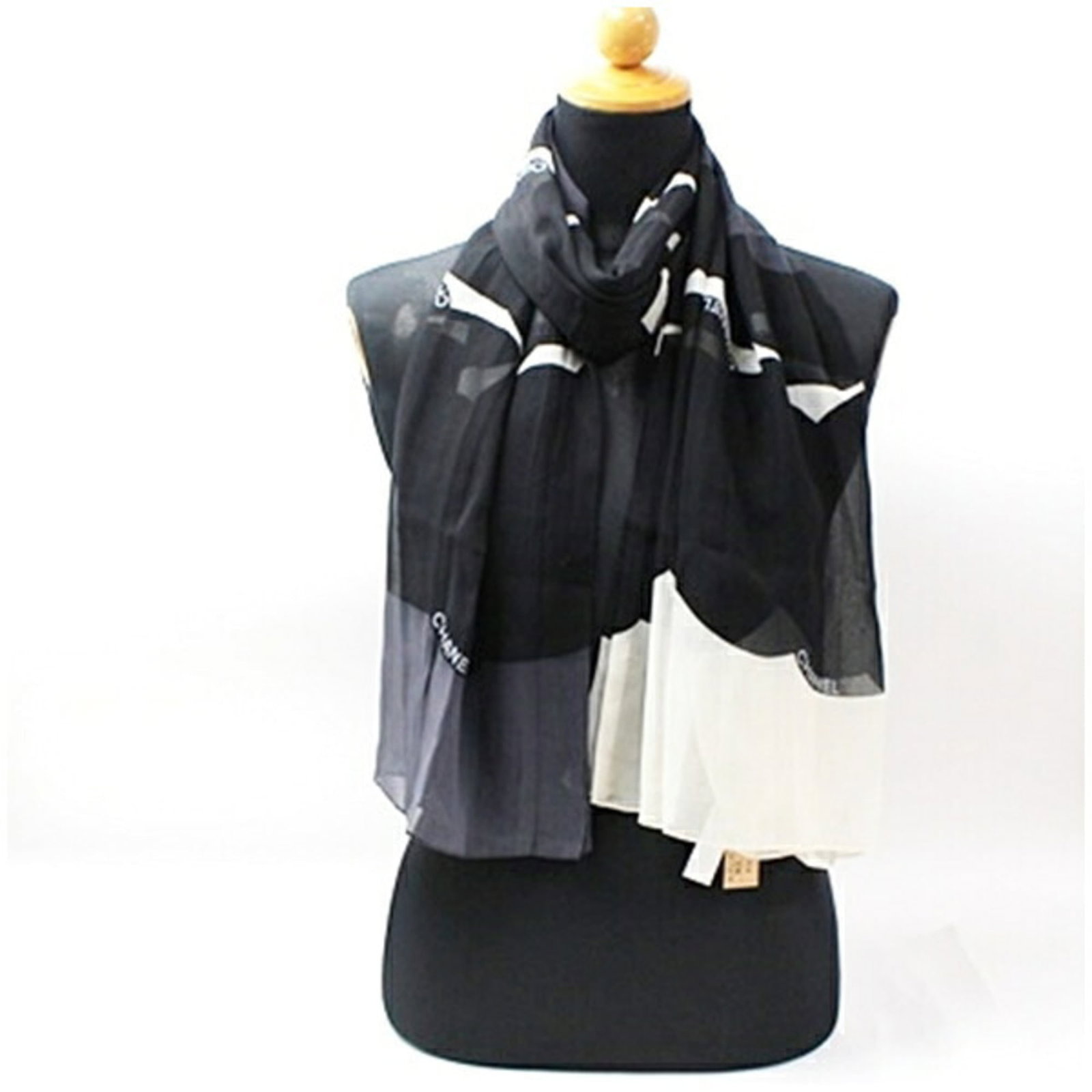 Silk Scarf Chanel: Silk Scarf Chanel Silk Scarf in Black and White, a timeless piece from the renowned fashion house Chanel, made from high-quality silk material. The scarf's sleek design and elegant color palette make 