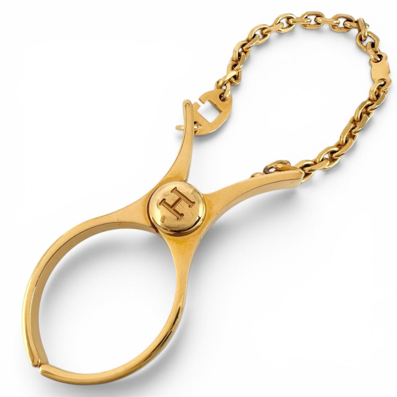 Glove Holder by Hermes: Glove Holder by Hermes Gold Glove Holder by Hermes. This elegant gold glove holder bears a signature, adding a touch of sophistication to any room. Its luxurious gold finish makes a statement, showcas