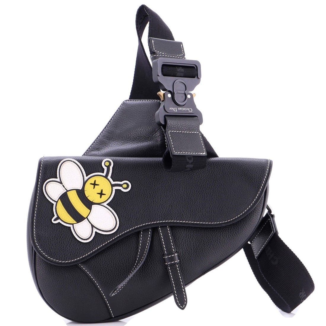 Saddle Crossbody Bag Leather with Christian Dior KAWS Applique: Saddle Crossbody Bag Leather with Christian Dior KAWS Applique The Christian Dior KAWS Saddle Crossbody Bag Leather features a striking black leather exterior adorned with a bold applique. This stylis