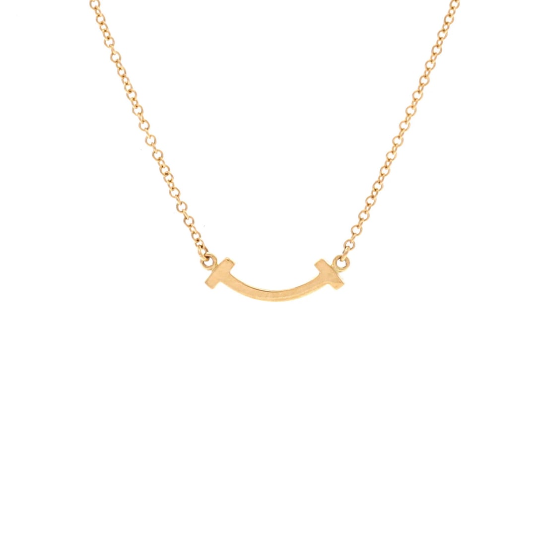 Tiffany & Co T Smile Pendant Necklace 18K Yellow Gold Mini: Tiffany & Co T Smile Pendant Necklace 18K Yellow Gold Mini 18K Yellow Gold Mini T Smile Pendant Necklace from Tiffany & Co. is a delicate 16.0-18.0" necklace featuring a 4.50mm x 14.05mm 18K Yellow