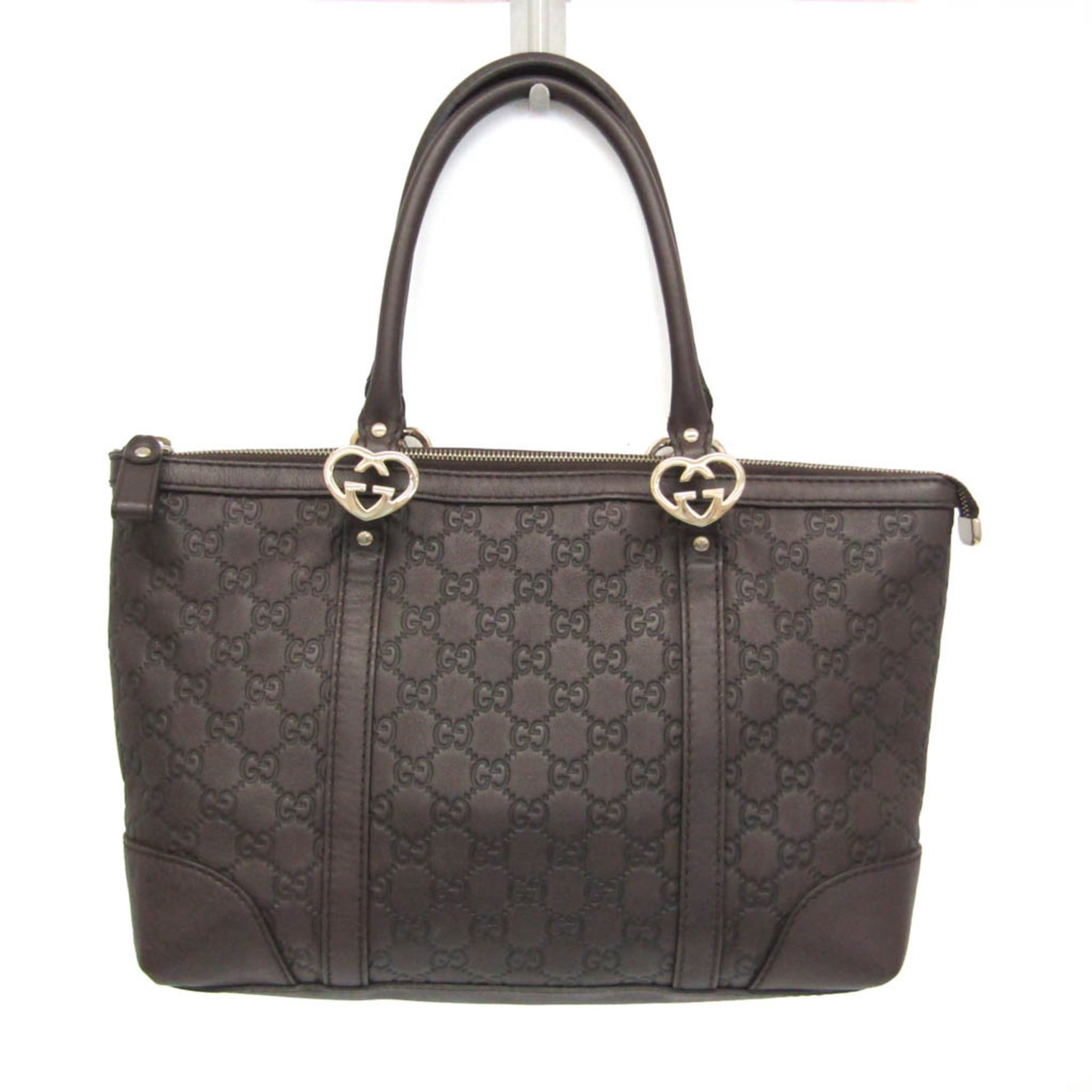Tote Handbag Leather Gucci Bag: Tote Handbag Leather Gucci Bag Dark brown Gucci leather tote bag with embossed design, featuring a zipper closure, one zipper pocket, and one open pocket, measures 23cm x 32cm x 13cm. The bag has a