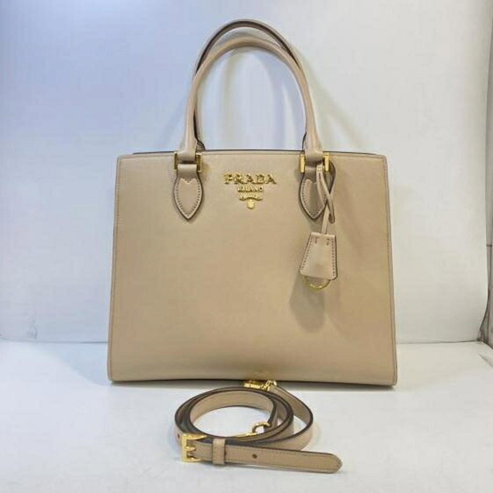 Tote Bag Prada: Tote Bag Prada Prada Country of Origin: Romania. This beige tote bag features a signature and measures 25cm x 30cm x 11.5cm. Made in Romania, the bag's dimensions are 9.84'' x 11.81'' x 4.52''. Item