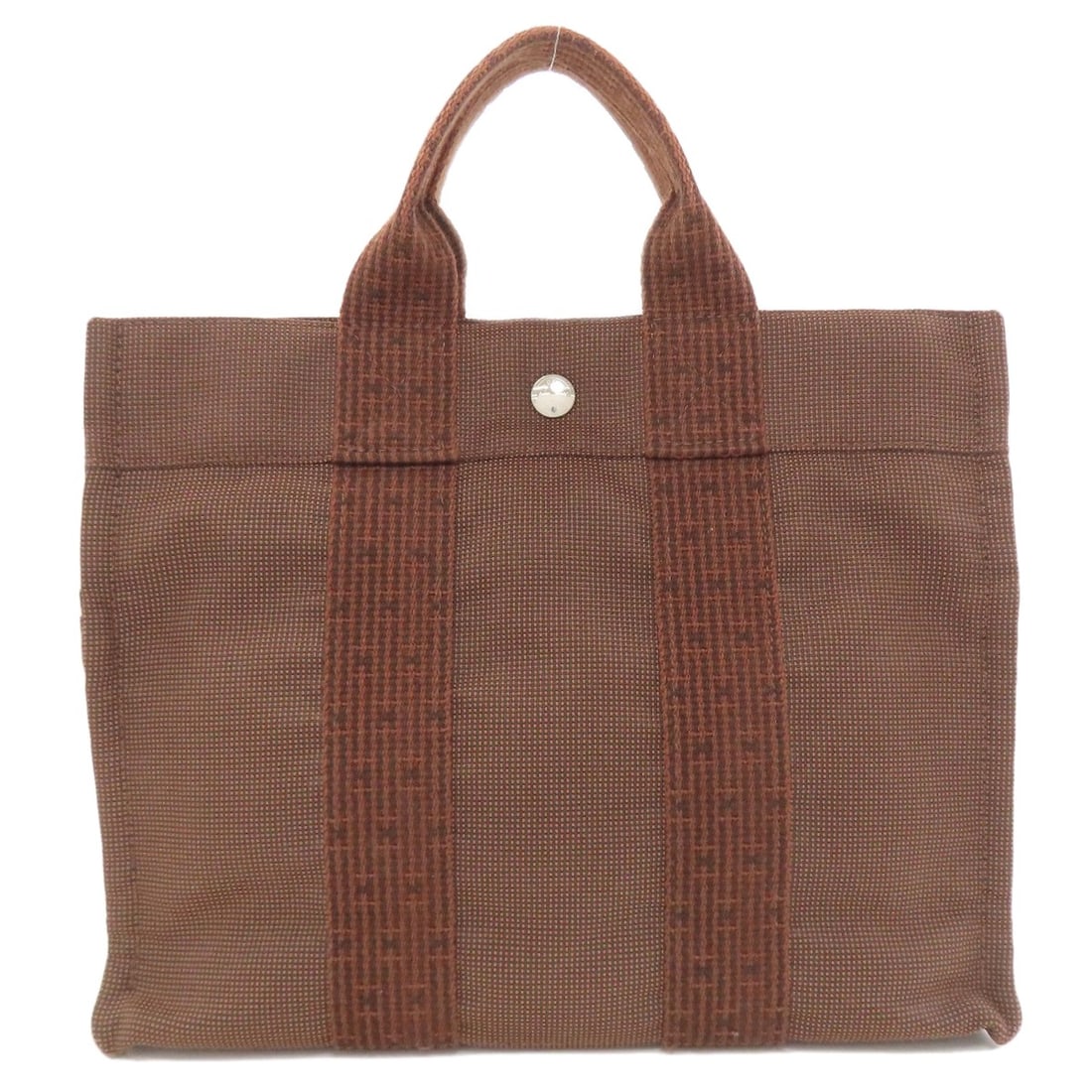 Hermes Her Linepm Handbag Canvas: Hermes Her Linepm Handbag Canvas Brown canvas handbag from HERMES' Her Linepm collection. This canvas handbag features a classic design with a brown exterior. The canvas material gives it a unique