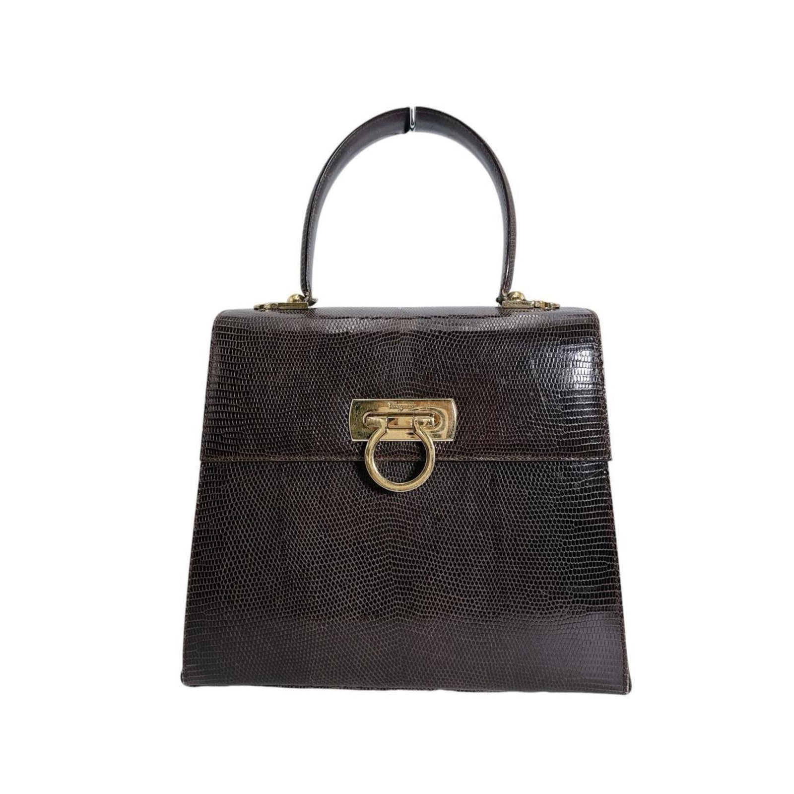 Salvatore Ferragamo Handbag Leather: Salvatore Ferragamo Handbag Leather This Salvatore Ferragamo handbag is crafted from high-quality embossed leather, featuring a classic brown color. Made in Italy, the bag measures 22cm x 26.5cm x