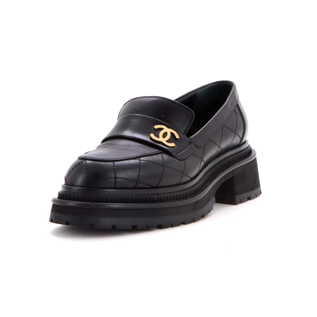 Chanel Women Quilted Leather CC Loafers: Chanel Women Quilted Leather CC Loafers Black quilted leather CC loafers from Chanel, featuring gold hardware and a classic design. The shoes have a worn, pre-loved look with creases and scuffs