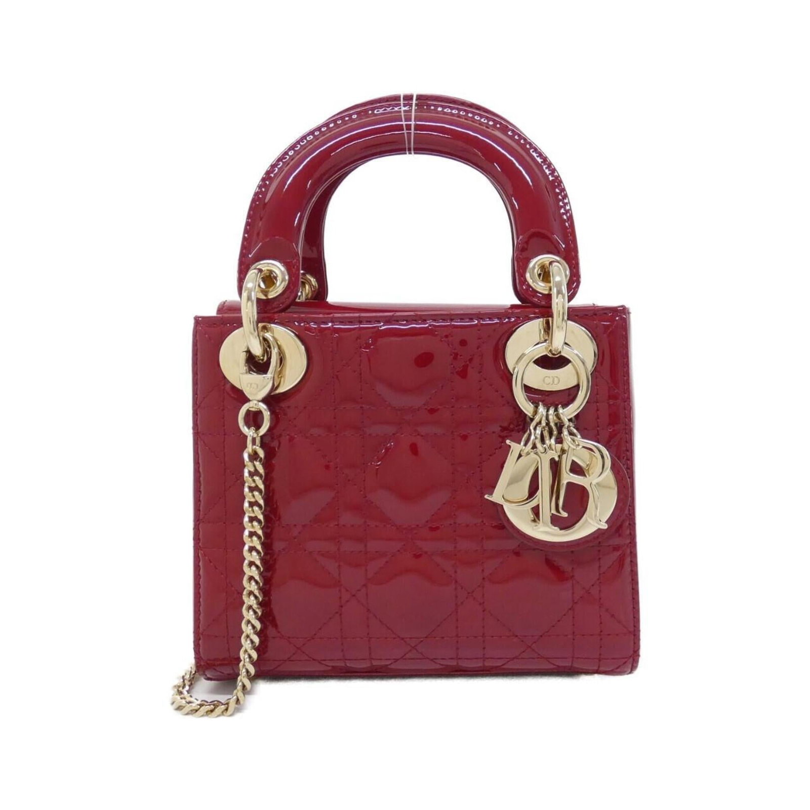Handbag Leather Dior Christian: Handbag Leather Dior Christian Cherry red leather handbag from the Lady Dior collection, featuring gold hardware and a sleek, compact design. Measuring 14cm x 17cm x 7cm, this stylish accessory is