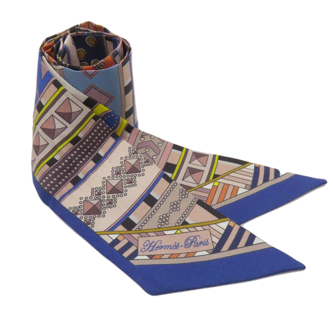 Hermes Silk Twilly Scarf: Hermes Silk Twilly Scarf Navy silk twilly scarf from the iconic HERMES brand, characterized by its open closure and classic navy exterior. This elegant accessory is crafted from high-quality silk, sho