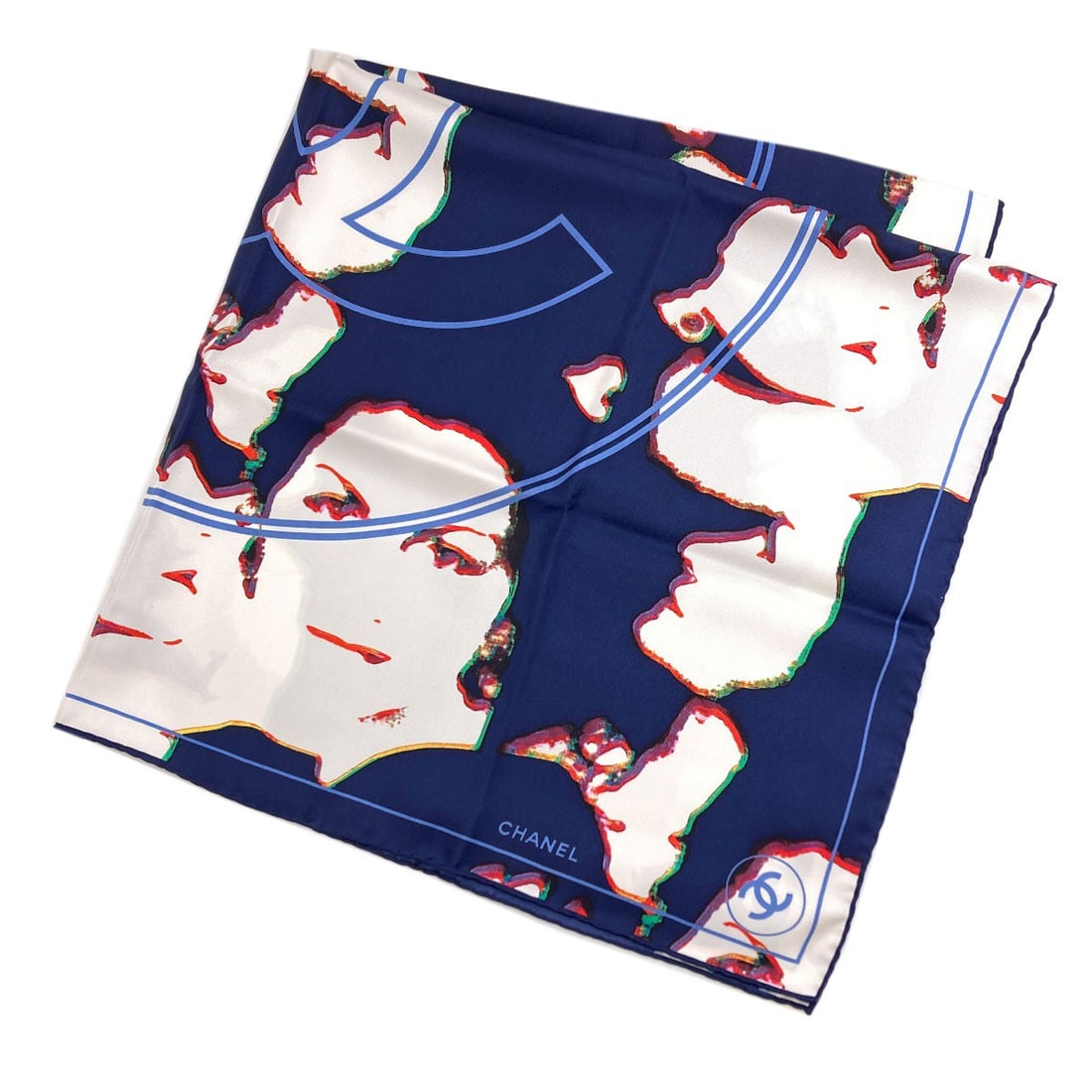 Silk Coco Human Mark Scarf Motif Chanel: Silk Coco Human Mark Scarf Motif Chanel Navy silk scarf with a Coco Human Mark motif, a distinctive design element characteristic of CHANEL's signature style. This scarf features a classic navy