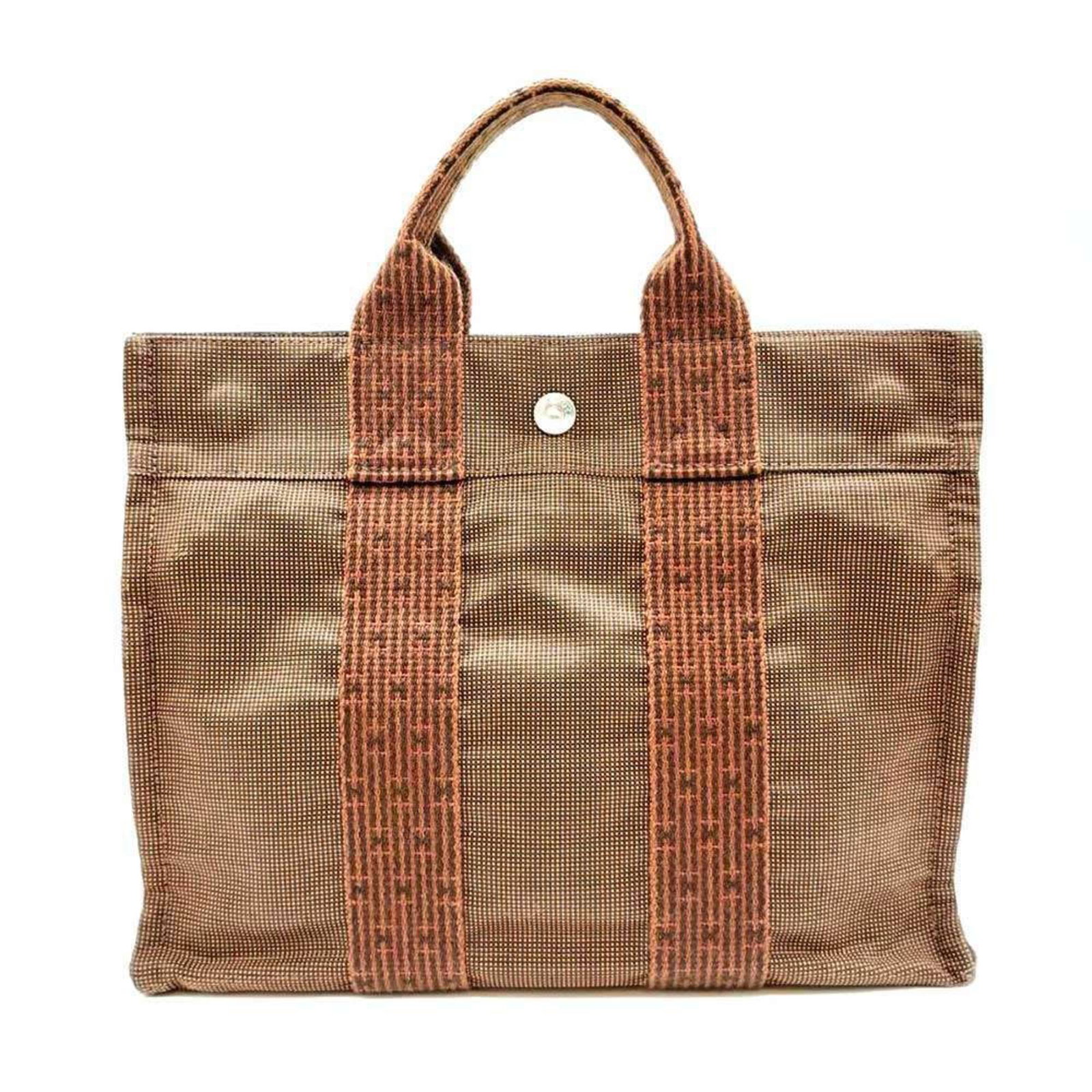 Handbag Tote Bag Canvas Hermes: Handbag Tote Bag Canvas Hermes Canvas tote bag from the Hermes Line, featuring a classic brown color and casual style. Made from high-quality canvas material, this bag measures 23cm x 30cm x 8cm and h