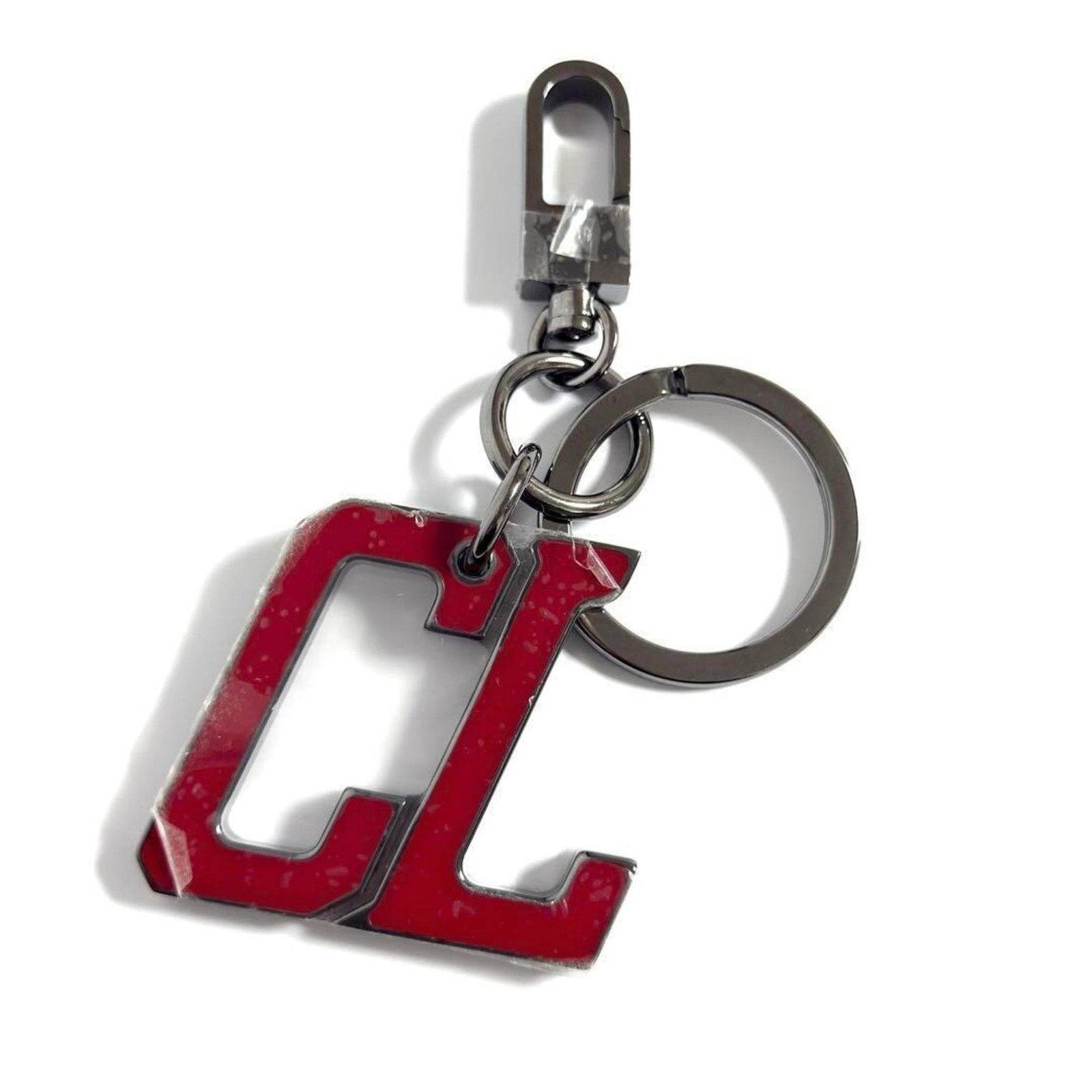 Christian Louboutin Metal Keyring: Christian Louboutin Metal Keyring The Christian Louboutin Metal Keyring is a sleek accessory, measuring 11cm x 5.5cm, featuring a metal design. It comes with a dust bag for added protection. A