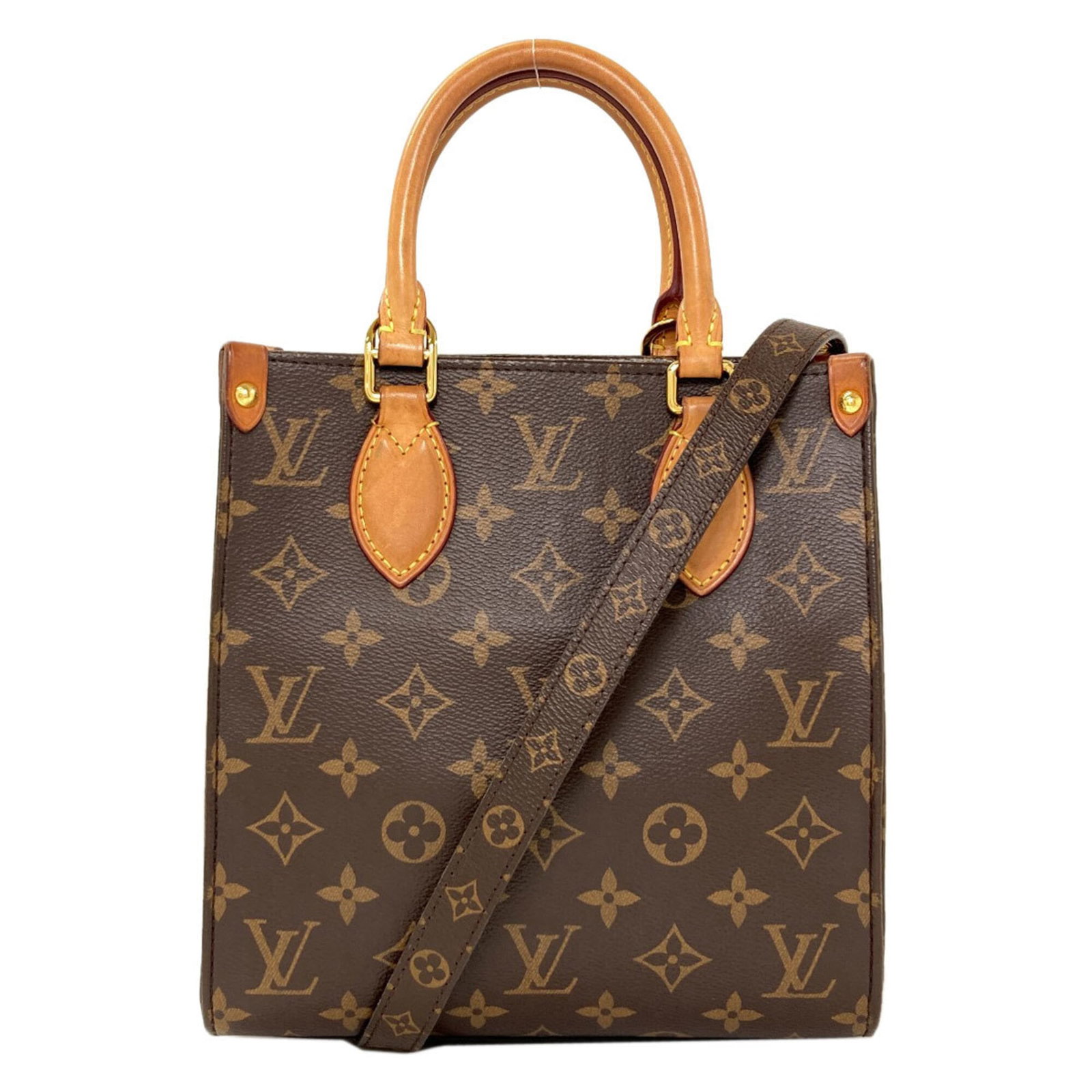Louis Vuitton Monogram Handbag: Louis Vuitton Monogram Handbag Monogram pattern adorns this Louis Vuitton handbag, adding visual interest to its sleek design. The bag's compact size and durable construction make it a practical