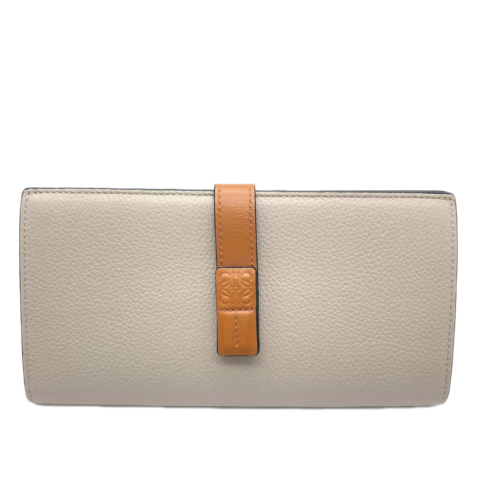 Loewe Long Wallet (Bi-Fold): Loewe Long Wallet (Bi-Fold) The Loewe Long Wallet (Bi-Fold) boasts a sleek, beige brown design with a vibrant orange accent, adding a pop of color to any accessory collection. Measuring 9cm x 17.5cm