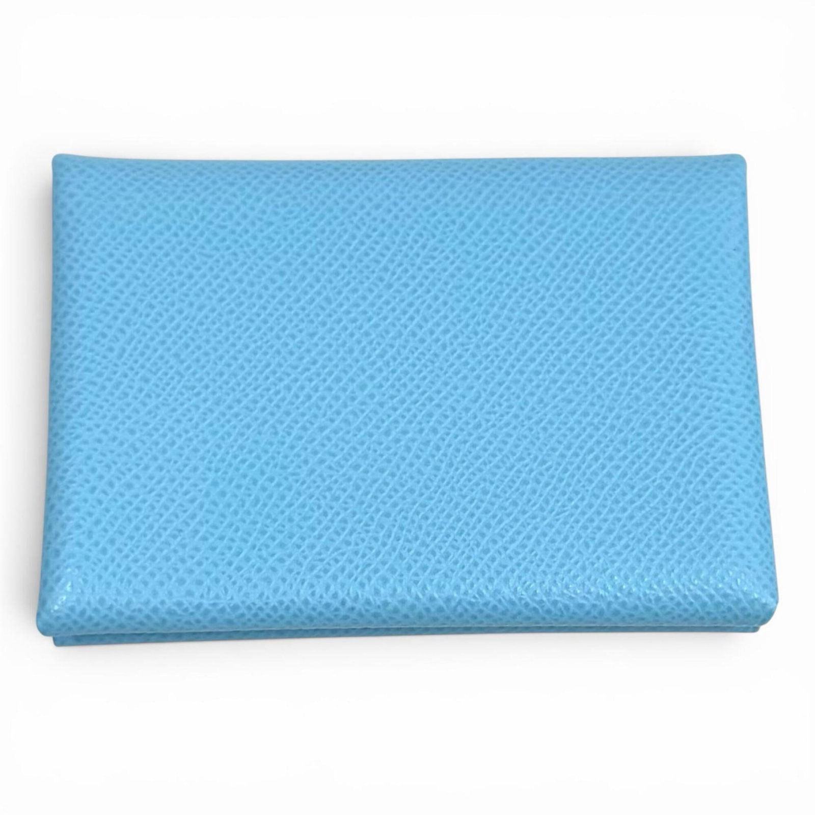 Bi fold Epsom Leather Hermes Wallet: Bi fold Epsom Leather Hermes Wallet Epsom leather construction provides a luxurious feel to this bi-fold wallet from Hermes, with a Celeste color that adds a touch of elegance. The wallet's compact