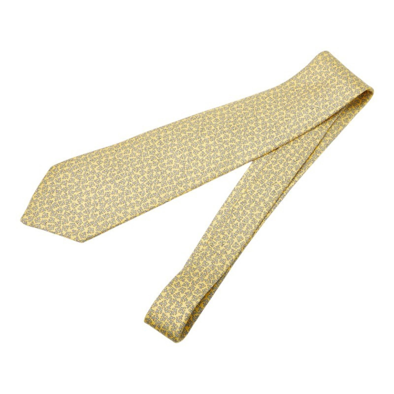 Silk Cravat Hermes: Silk Cravat Hermes Silk Cravat in vibrant yellow, crafted from high-quality silk, measures 47cm in length. This cravat bears a signature, a notable feature of the item. Made from luxurious silk, it is