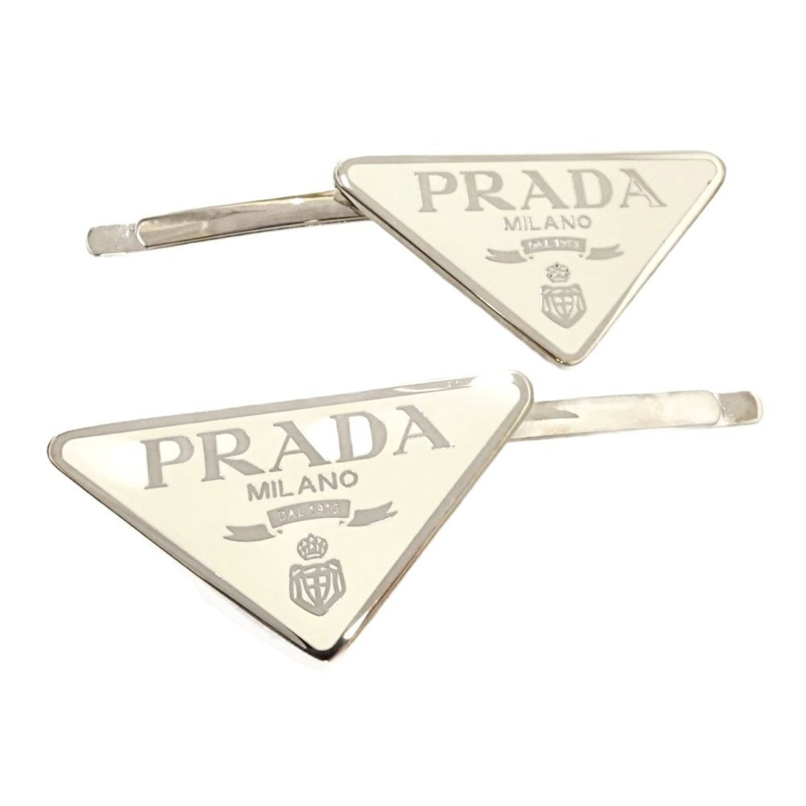 Metal Hair Clip Prada: Metal Hair Clip Prada Metal Hair Clip Prada is a pair of white metal hair clips bearing the Prada brand. Each clip is made of metal and comes in a pack of two. The Prada brand is known for its high-en