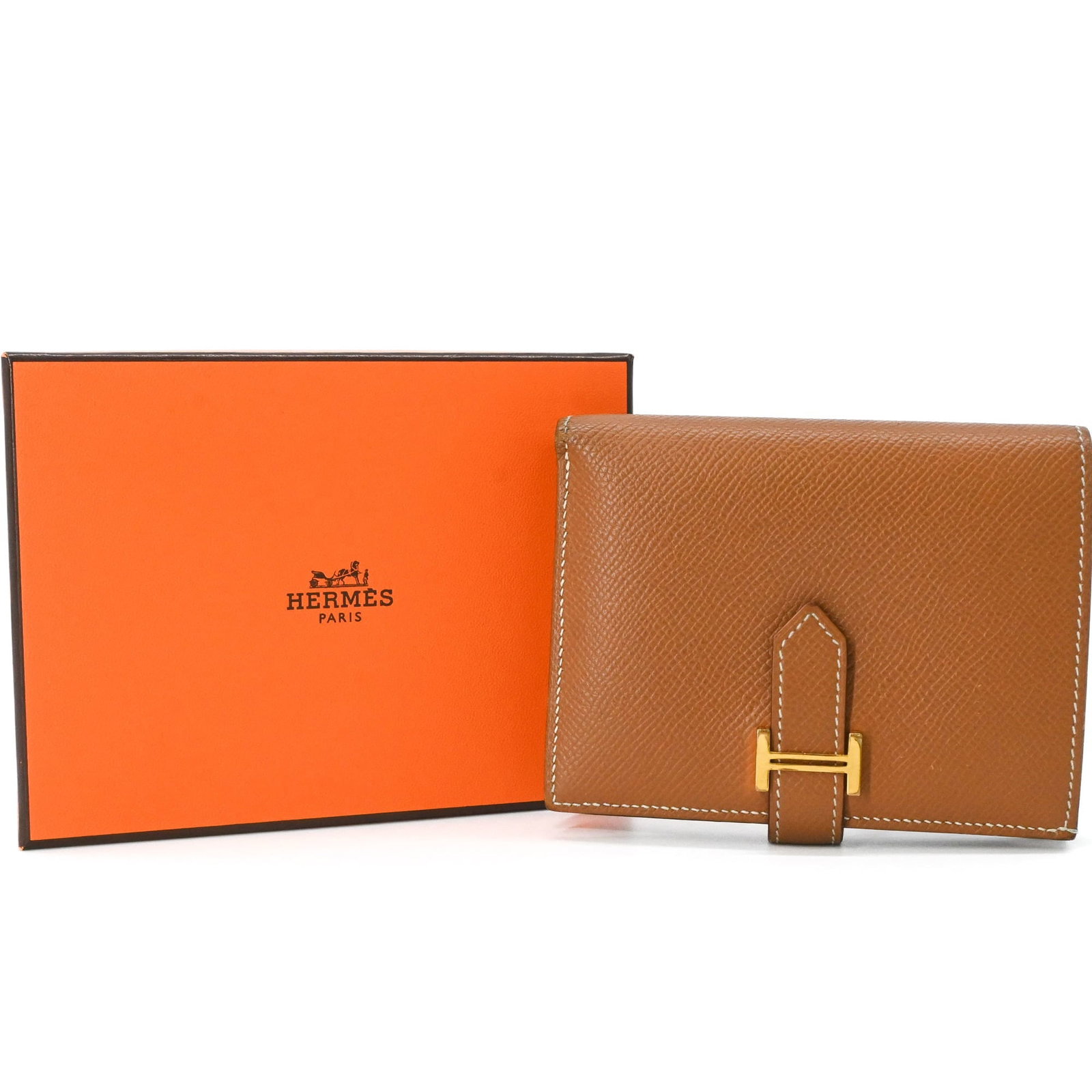 Bi fold Epsom Leather Hermes Wallet: Bi fold Epsom Leather Hermes Wallet Epsom leather provides a rich, luxurious feel to this bi-fold wallet from Hermes, with its gold brown hue adding a touch of sophistication. Measuring 9cm x 11.8cm x