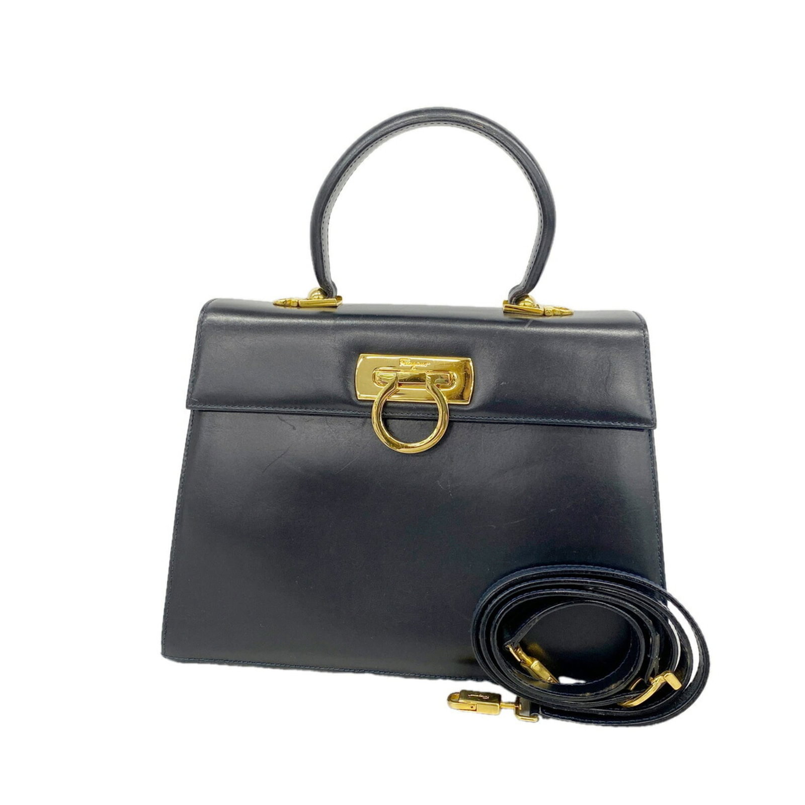 Salvatore Ferragamo Handbag Leather: Salvatore Ferragamo Handbag Leather Salvatore Ferragamo Handbag Leather is a navy leather handbag with gold hardware, measuring 20cm x 27.5cm x 10cm. The bag's classic design and timeless color make