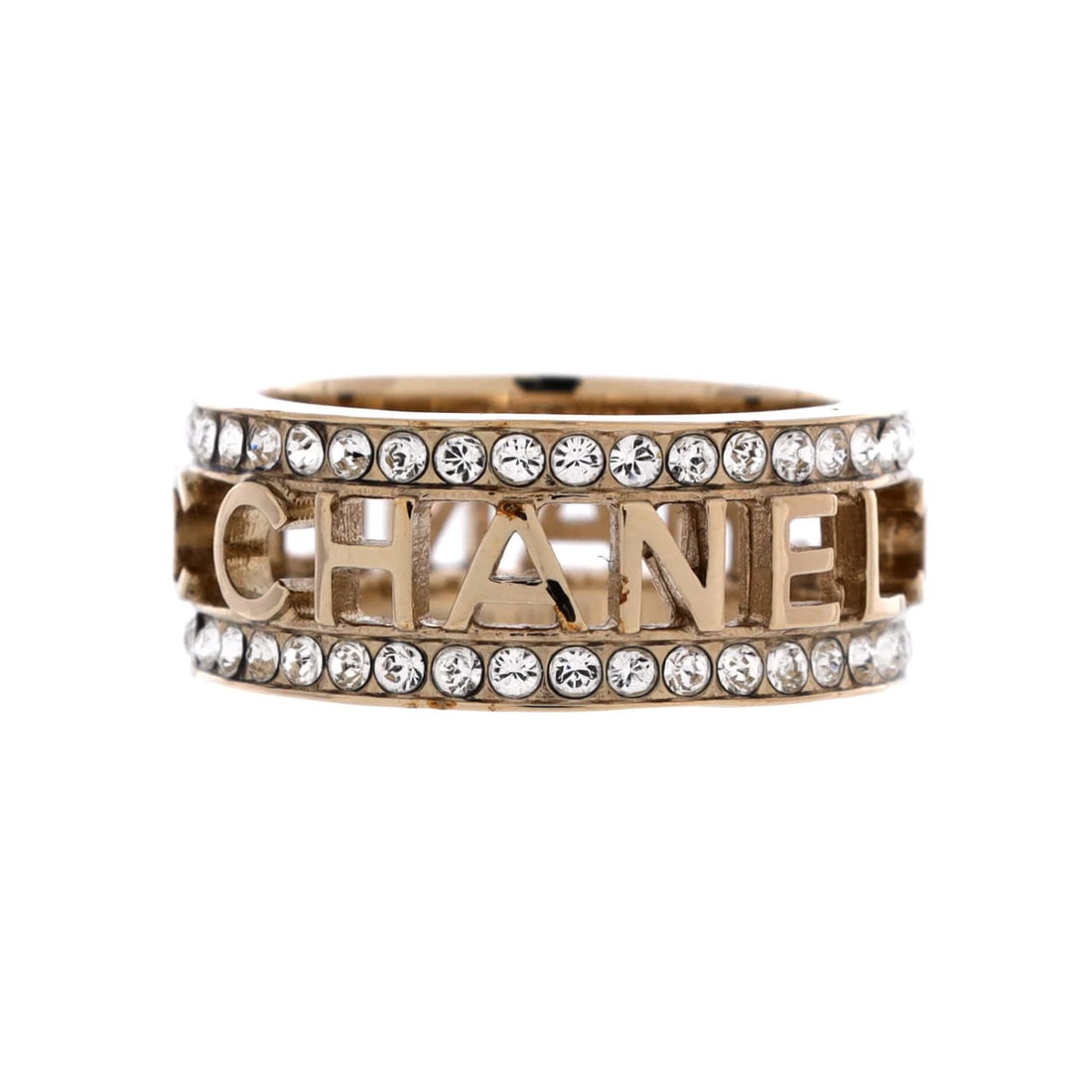 Bow-tiful Metal Ring with Chanel Logo Crystals: Bow-tiful Metal Ring with Chanel Logo Crystals The Bow-tiful Metal Ring with Chanel Logo Crystals boasts a stunning gold exterior, adorned with crystal metal that adds a touch of elegance to this