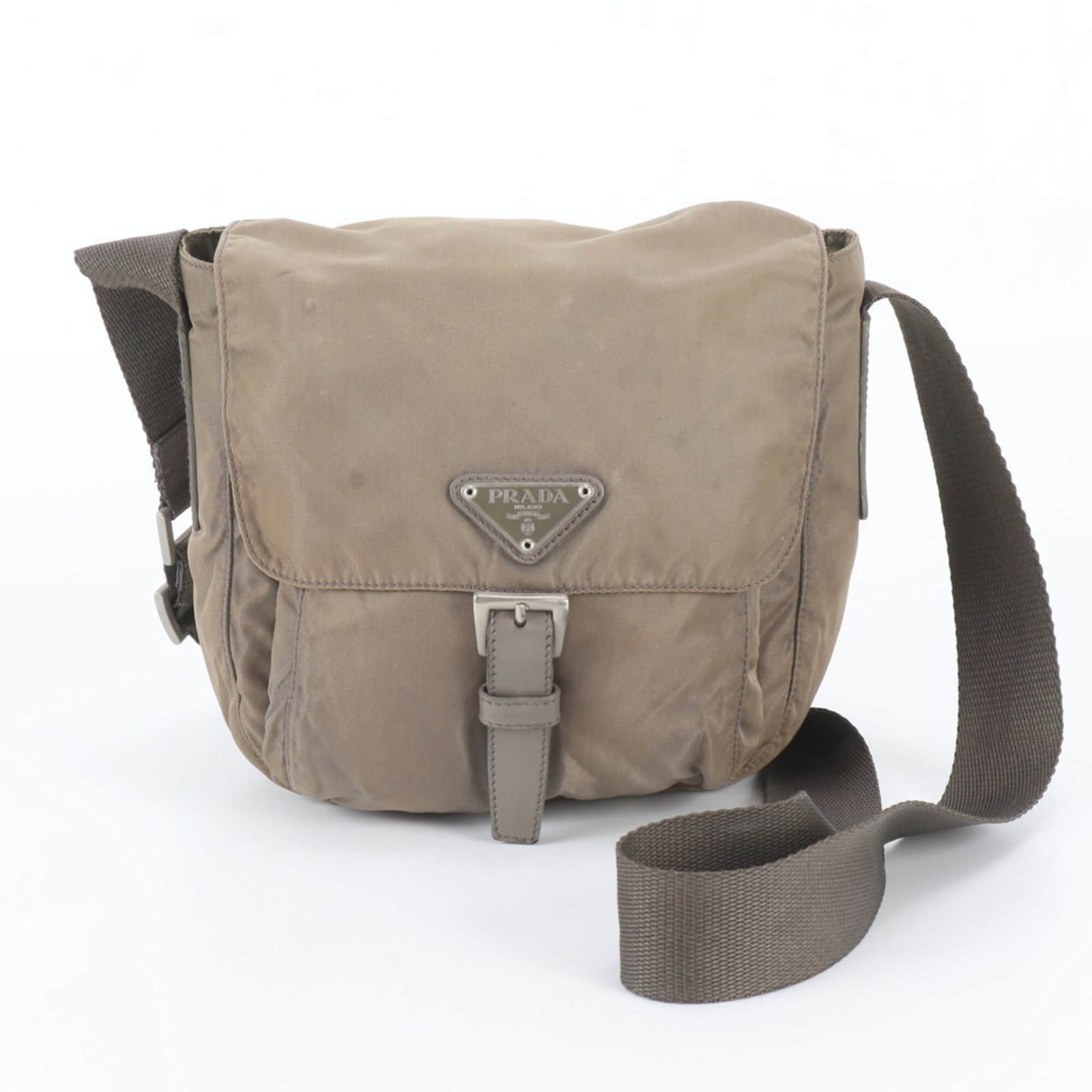 Shoulder Bag By Prada: Shoulder Bag By Prada Prada's khaki shoulder bag boasts a sleek 17cm x 17cm x 12cm design, making it a stylish and compact accessory. The bag's Country of Origin is Italy, reflecting the brand's herit