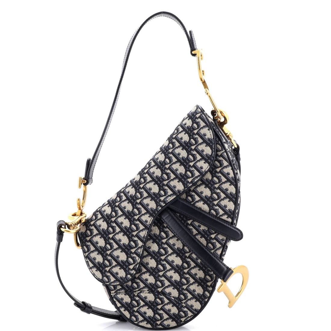Saddle Handbag Strap Oblique Canvas Medium Christian Dior: Saddle Handbag Strap Oblique Canvas Medium Christian Dior Saddle Handbag with Strap Oblique Canvas Medium from Christian Dior features a striking blue canvas exterior with oblique design,