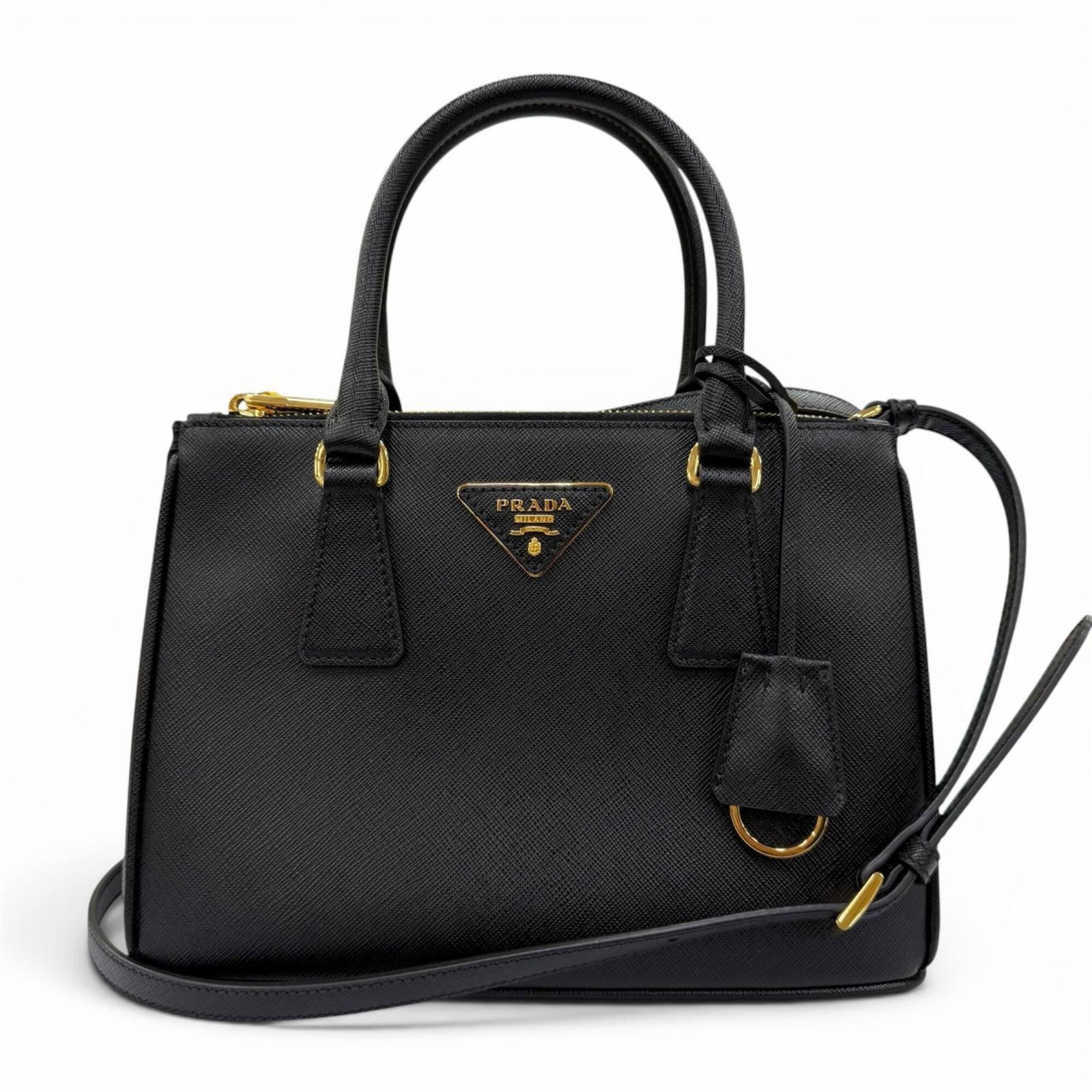 Prada Handbag Shoulder Bag Leather: Prada Handbag Shoulder Bag Leather Saffiano leather handbag with gold hardware, featuring a sleek and sophisticated design. Made from high-quality leather, this shoulder bag measures 17cm x 23.5cm x 1