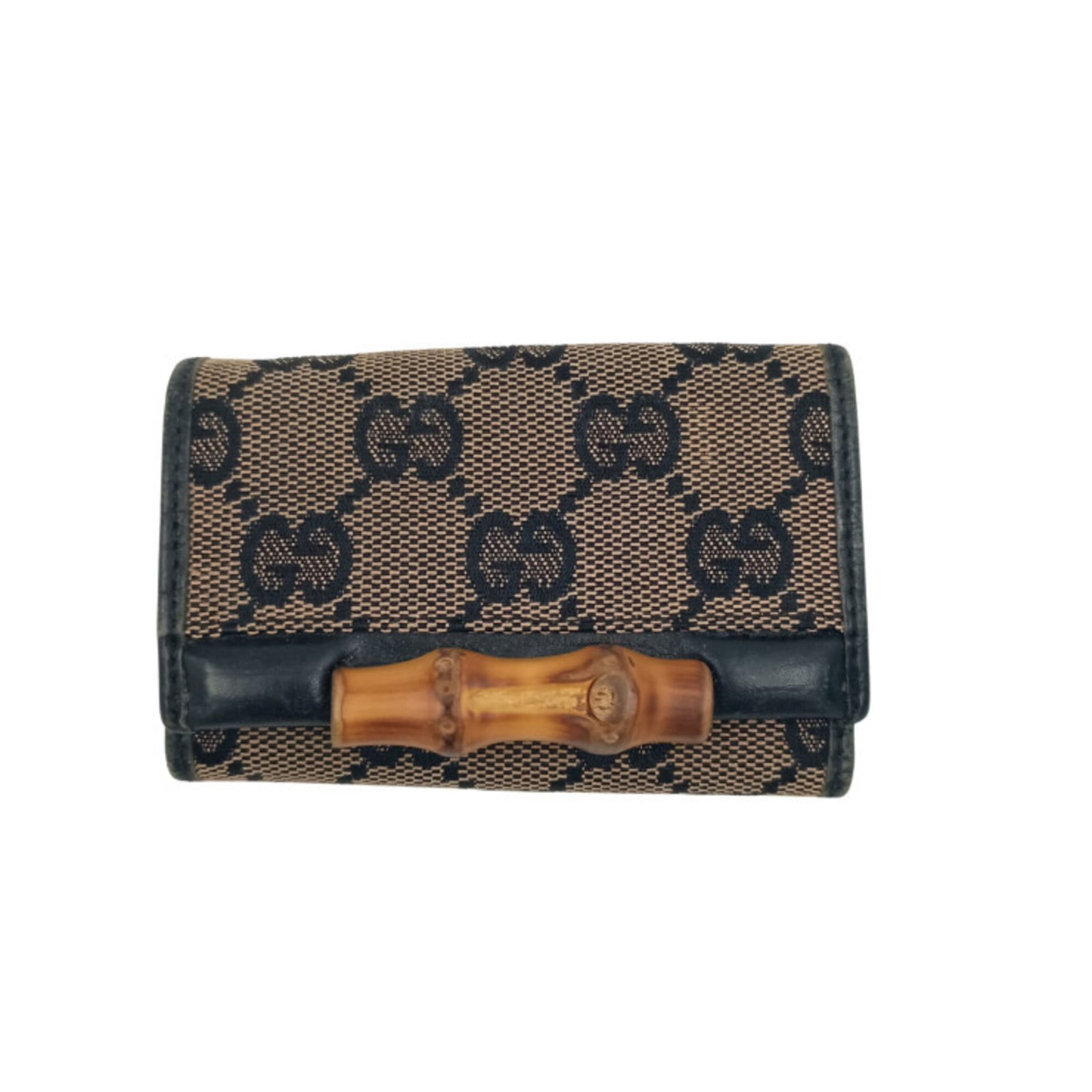 Gucci Canvas Leather Keycase: Gucci Canvas Leather Keycase GG canvas and leather combine in this sleek Gucci keycase, available in both black and brown colors. Measuring 6cm x 9.5cm x 2cm, it features a classic design that complem