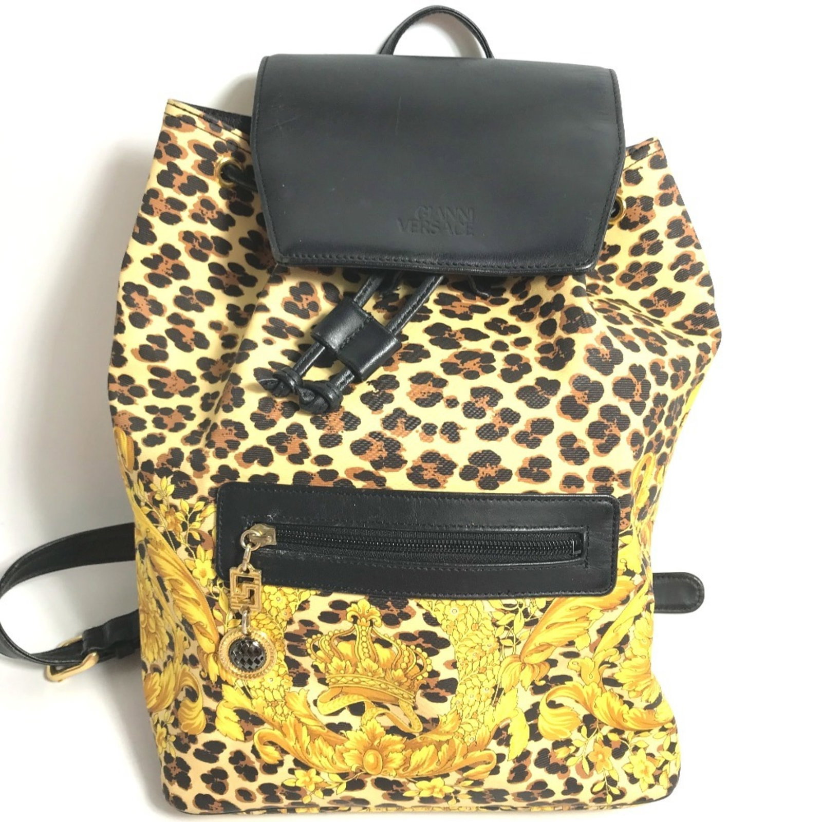 PVC Leather Versace Backpack: PVC Leather Versace Backpack PVC Leather Versace Backpack - A statement piece with a striking combination of PVC and leather materials, this black backpack features a bold yellow accent. Measuring