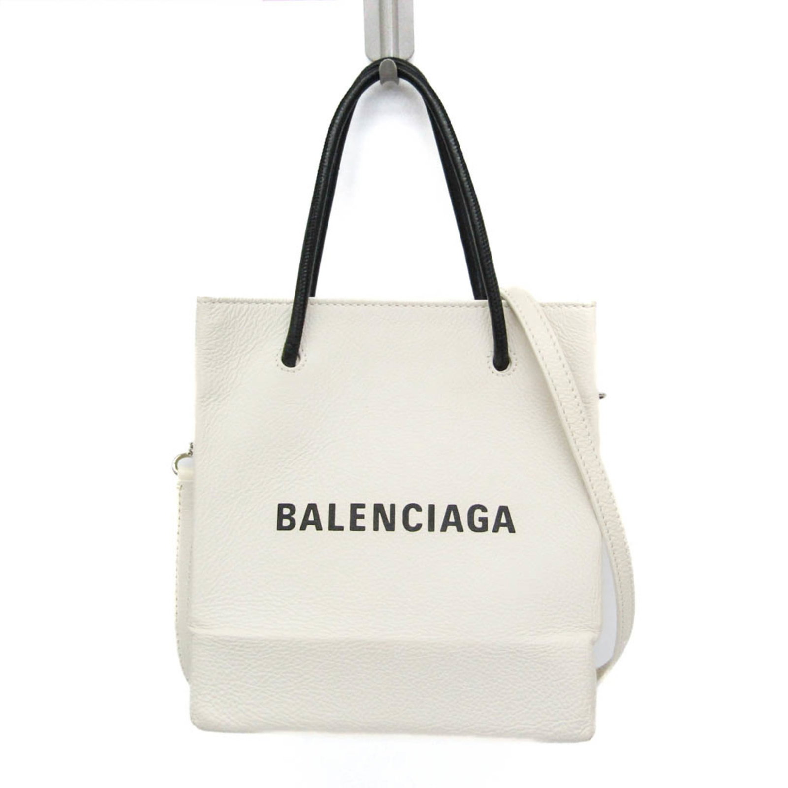 Balenciaga Shoulder Bag Tote Bag Leather: Balenciaga Shoulder Bag Tote Bag Leather White leather Balenciaga shoulder bag with a sleek design, featuring a zipper pocket and open pocket, adjustable strap, and a magnet closure. The bag's