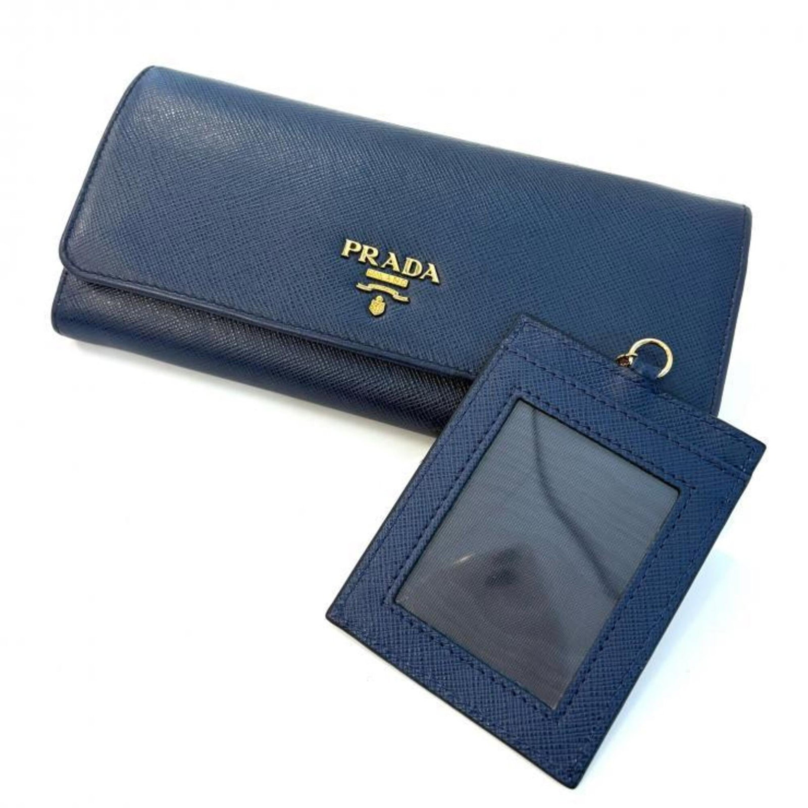 Prada Long Wallet (Bi-Fold) Saffiano Metal: Prada Long Wallet (Bi-Fold) Saffiano Metal Prada's Long Wallet (Bi-Fold) in Saffiano Metal boasts a sleek, structured design with a subtle Bluette and Navy color combination. The durable Saffiano