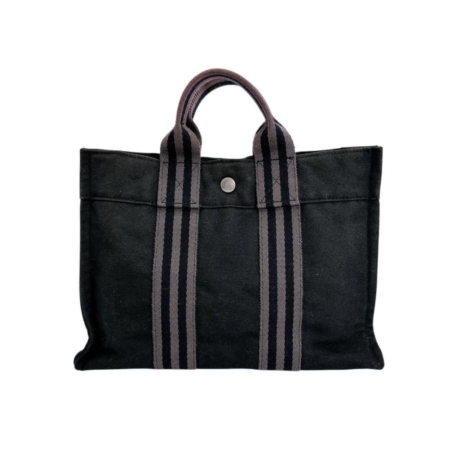 Handbag Tote Bag Canvas Hermes: Handbag Tote Bag Canvas Hermes Canvas Hermes tote bag in black, featuring a classic design with silver hardware and a snap fastener closure. This canvas tote bag measures 22cm x 30cm x 9cm and has a