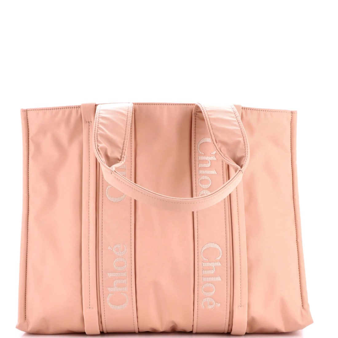 Chloe Woody Recycled Large Nylon Tote: Chloe Woody Recycled Large Nylon Tote Chloe's Woody Recycled Large Nylon Tote boasts a vibrant pink exterior and interior, made from durable recycled nylon. With a spacious interior and sturdy handles