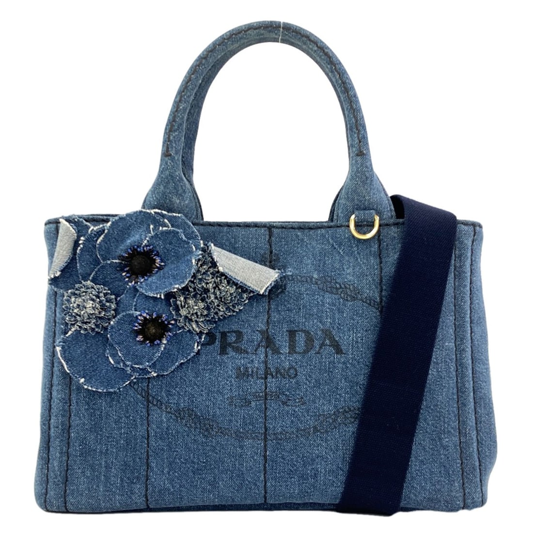 Prada Flower Mini Denim 2Way Canapa Handbag: Prada Flower Mini Denim 2Way Canapa Handbag Blue denim 2-way canapa handbag from PRADA, featuring a unique floral pattern. This stylish mini handbag is made from high-quality denim and boasts a