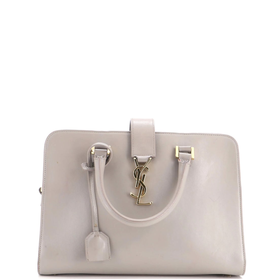 Cabas Leather Monogram Baby Saint: Cabas Leather Monogram Baby Saint The Saint Laurent Cabas Leather Monogram Baby Satchel features a classic design with a gray exterior and black interior, adorned with a gold monogram. Measuring 8"
