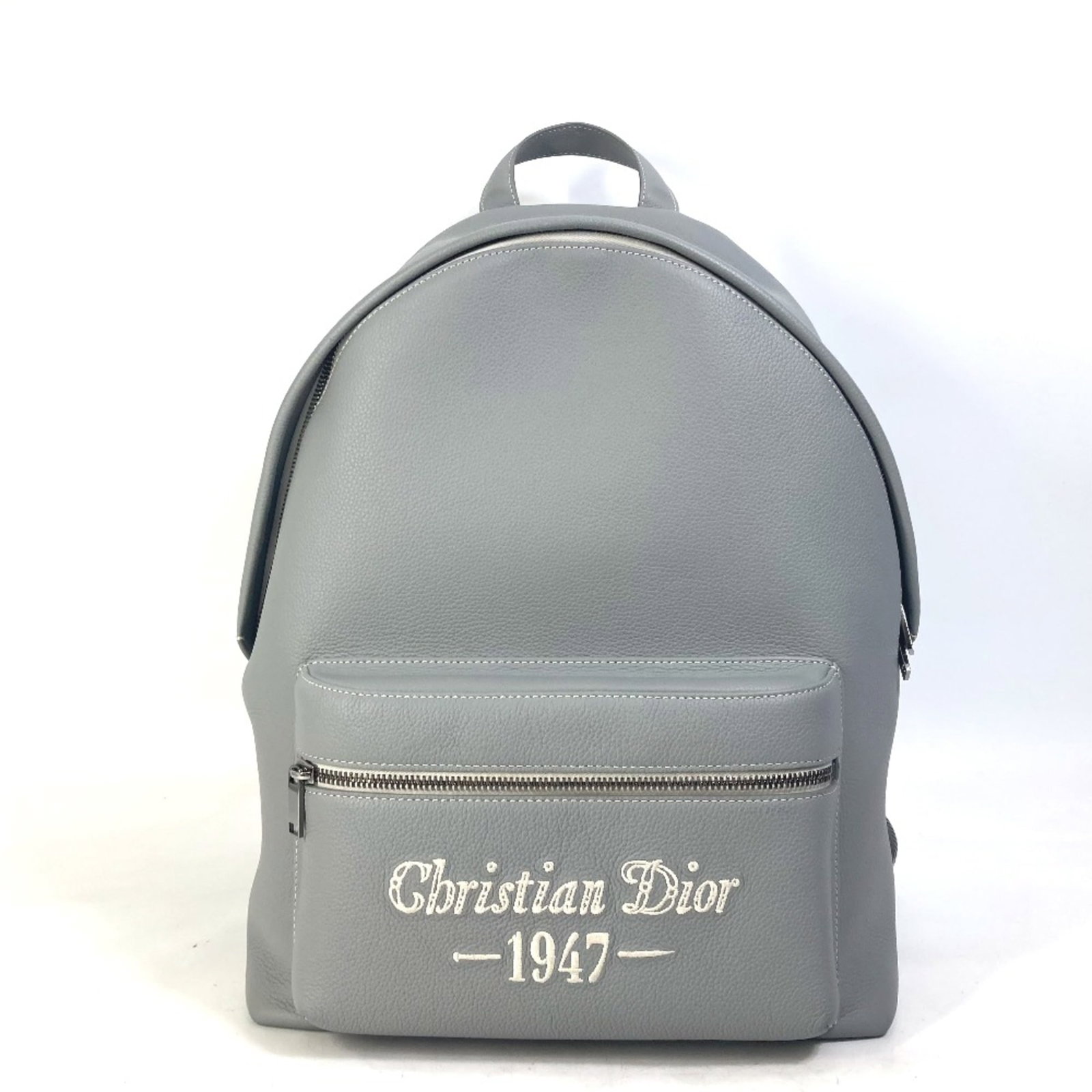 Christian Dior Leather Backpack: Christian Dior Leather Backpack Gray leather backpack with clean lines and classic design from Christian Dior, featuring a sturdy base and precise measurements. Made from high-quality leather, this