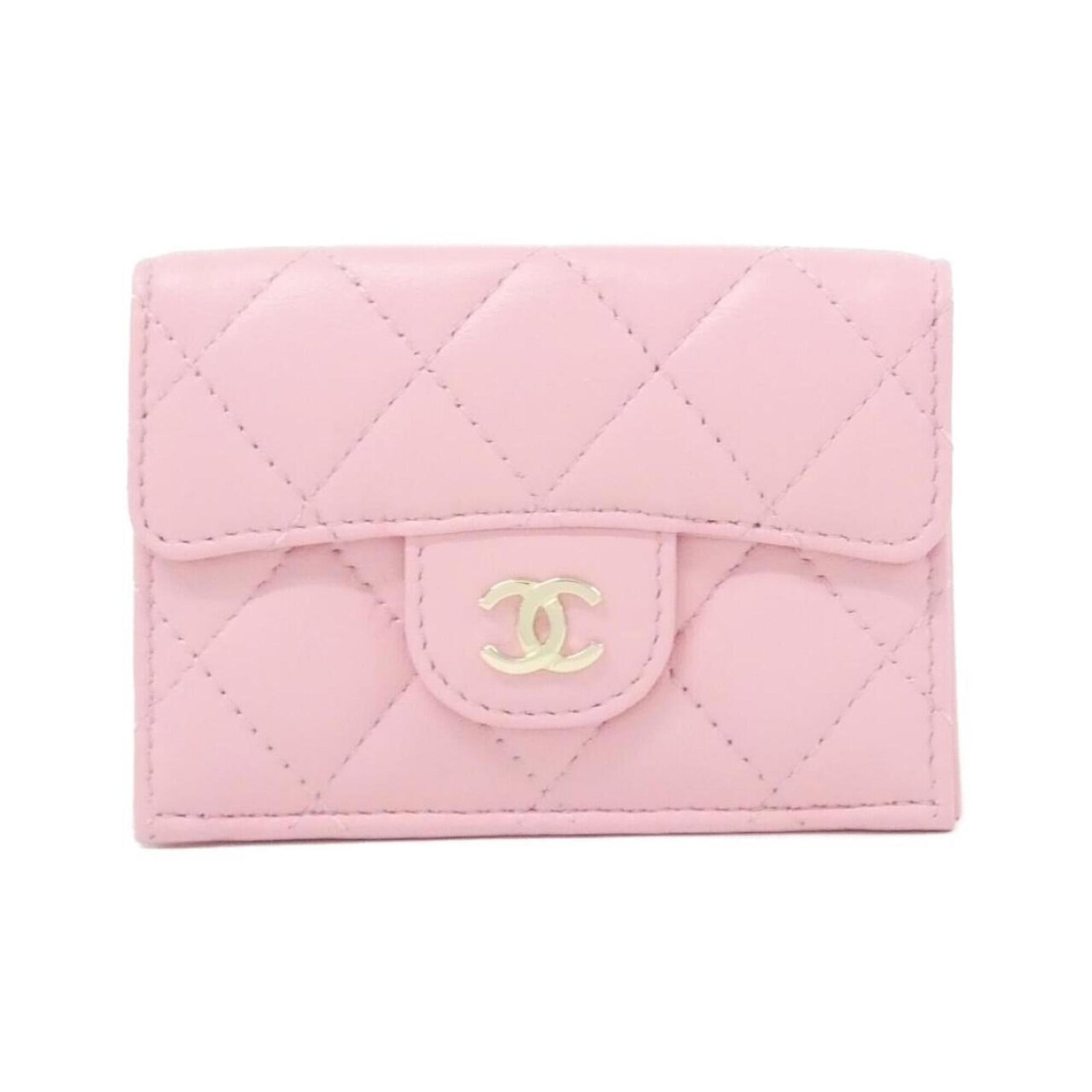 Chanel Wallet (Tri-Fold) Leather: Chanel Wallet (Tri-Fold) Leather Chanel's iconic tri-fold wallet is crafted from luxurious lamb leather in a vibrant pink hue. With its classic design and refined proportions, this wallet exudes timel