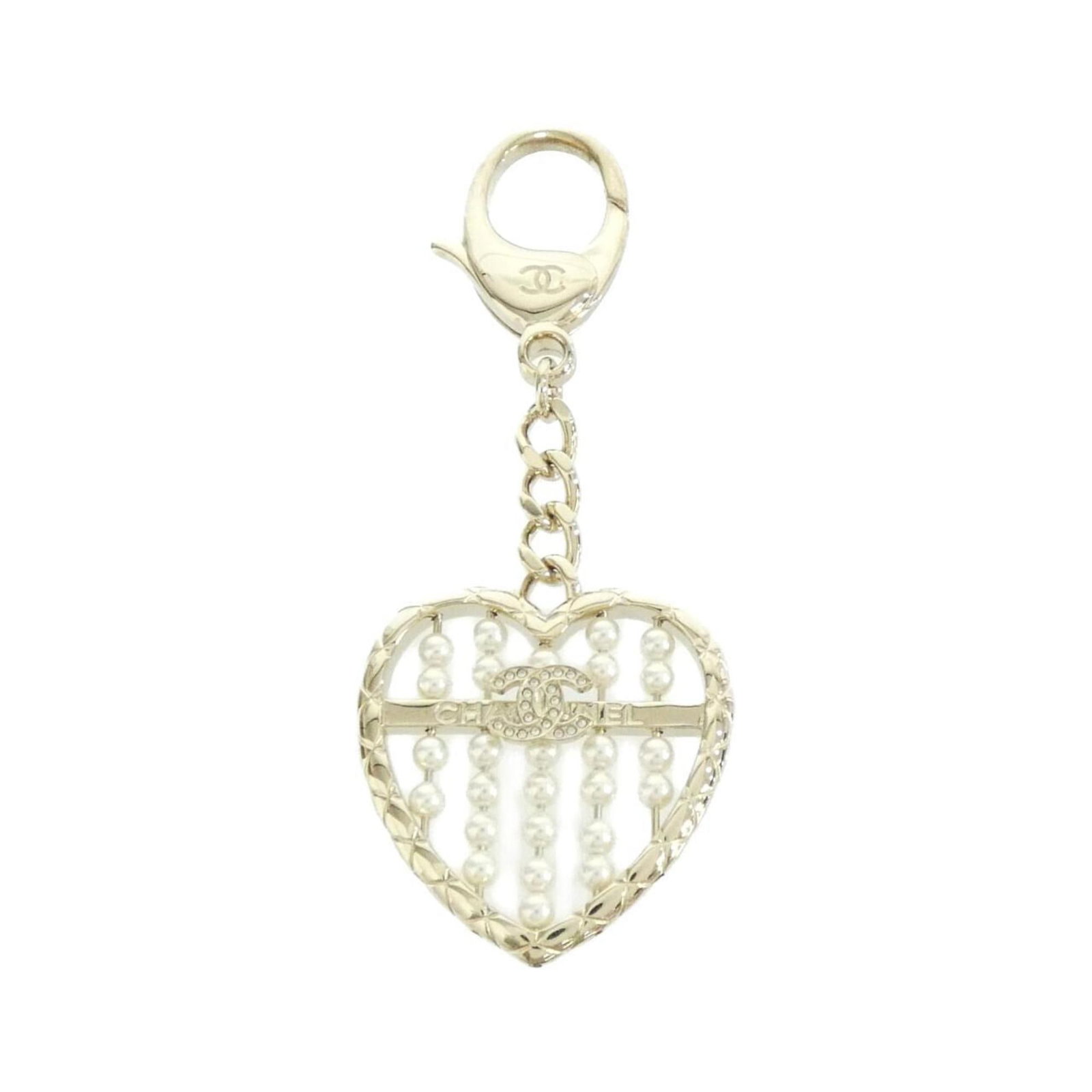 Keyring Artificial Pearl by Chanel: Keyring Artificial Pearl by Chanel Gold and White Artificial Pearl Keyring by Chanel, presented in a luxurious box. This elegant keyring showcases a striking artificial pearl, a signature element of