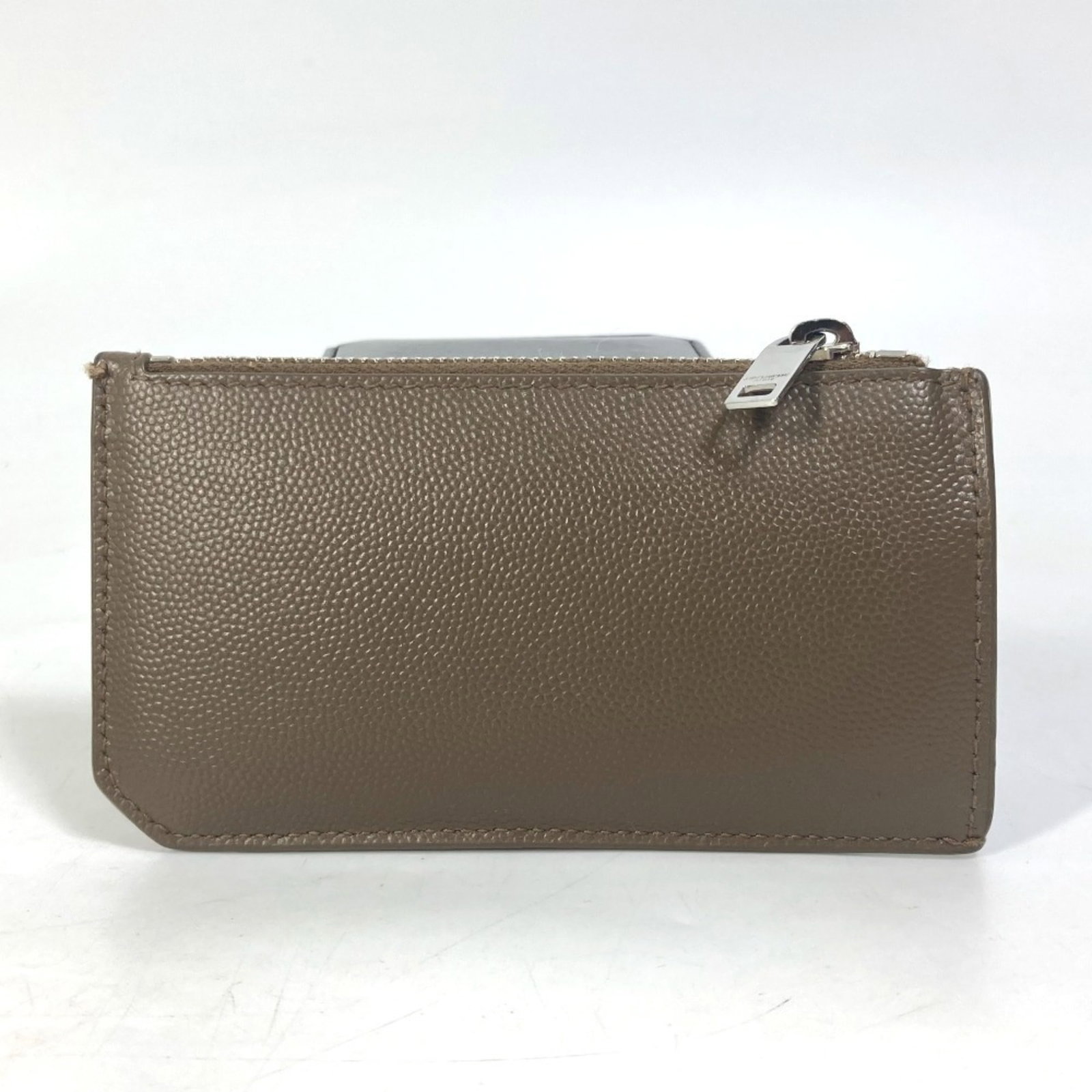 Yves Saint Laurent Leather Coin Purse: Yves Saint Laurent Leather Coin Purse The Yves Saint Laurent Leather Coin Purse is a stylish accessory featuring high-quality brown leather construction. Measuring 6.5cm x 12.5cm, it comes with a box 