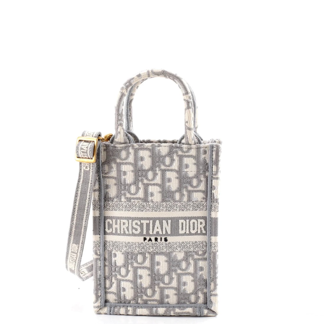 Christian Dior Oblique Mini Canvas Book Tote Phone Bag: Christian Dior Oblique Mini Canvas Book Tote Phone Bag Gray canvas mini tote bag with oblique design, featuring a gold-toned closure and interior storage for a phone. Measuring 7" high, 5" wide, and