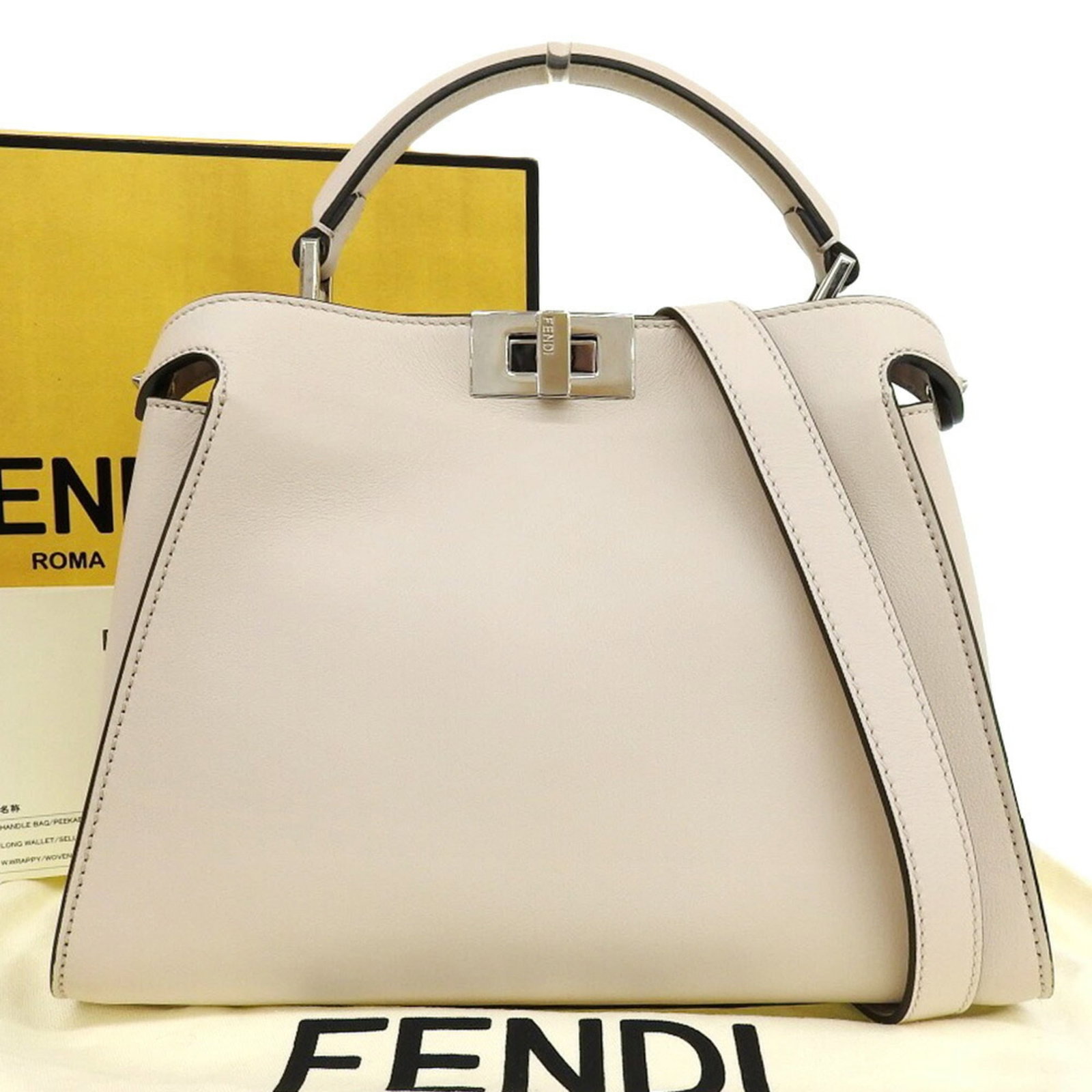 Shoulder Bag Leather Fendi Handbag: Shoulder Bag Leather Fendi Handbag Cream-colored leather Fendi Peekaboo shoulder bag with silver hardware and adjustable strap. This iconic essential features an open pocket and comes with a box, dust